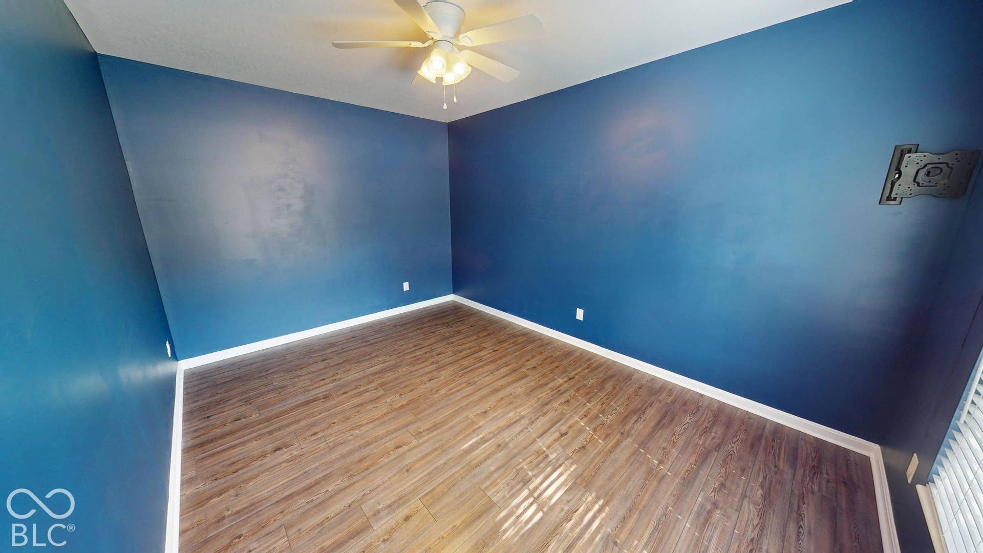 Warm wood-finish flooring with white trim