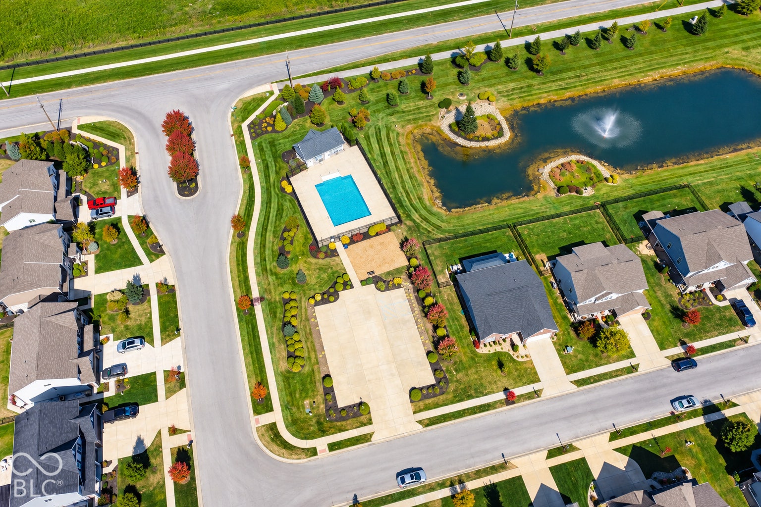 *AI - Color Enhancement* Community features an outdoor swimming pool, paved pool deck, and a pond with a water feature