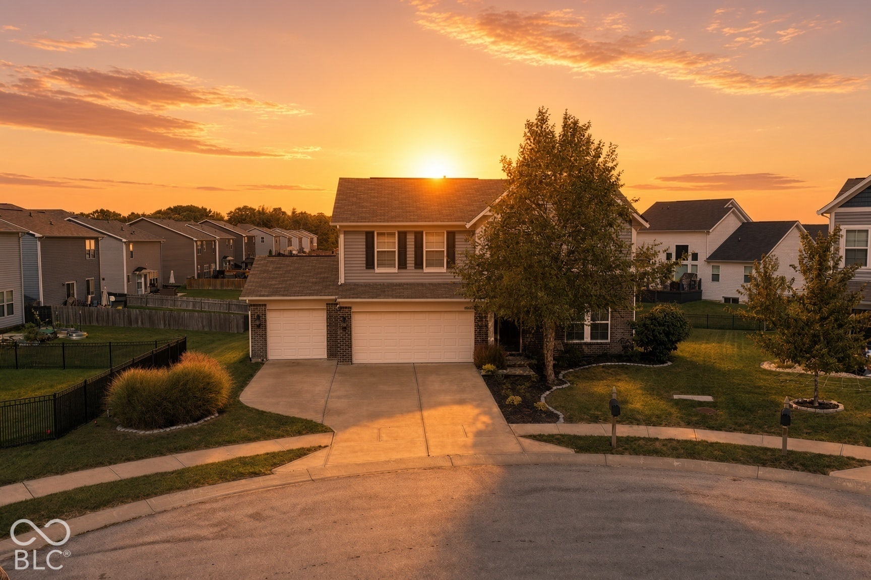 Virtually Altered - *AI - "SUNSET" Conversion * Two-story residence with a two-car garage, front yard landscaping, and fenced rear yard