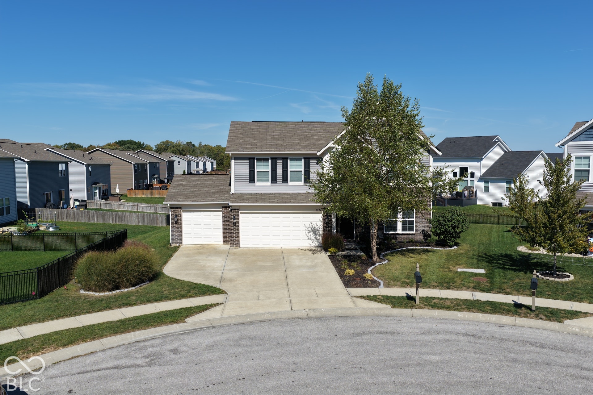 *Unaltered Exterior Stills* Two-story residence featuring a two-car garage, brick and siding exterior, front landscaping, and a concrete driveway