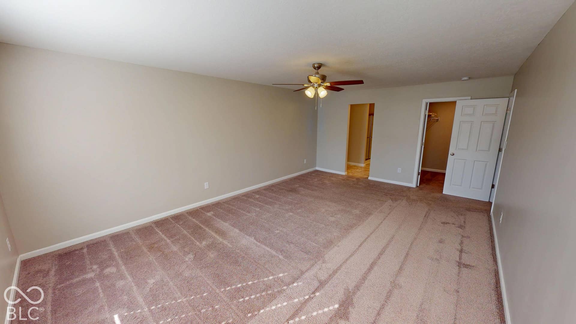 Bedroom # 3 | Spacious room with neutral wall tones, warm-toned carpeting, and a ceiling fan with integrated lighting