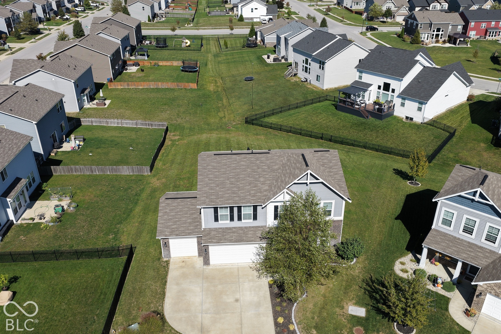 *Unaltered Exterior Stills* Two-story residence with a light gray exterior, white trim, and a shingle roof