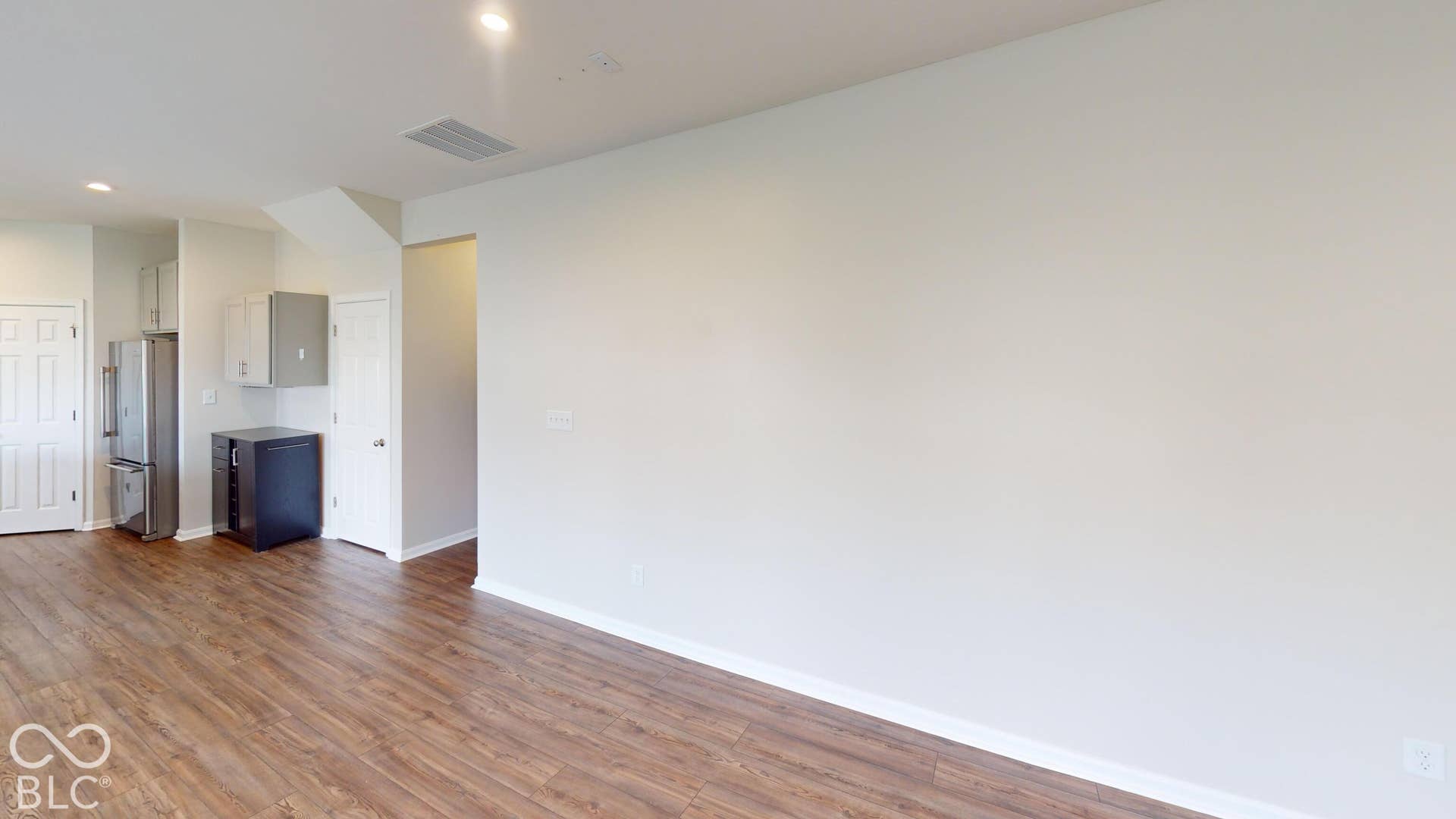 Wood-finish flooring throughout, recessed lighting, and stainless steel appliances