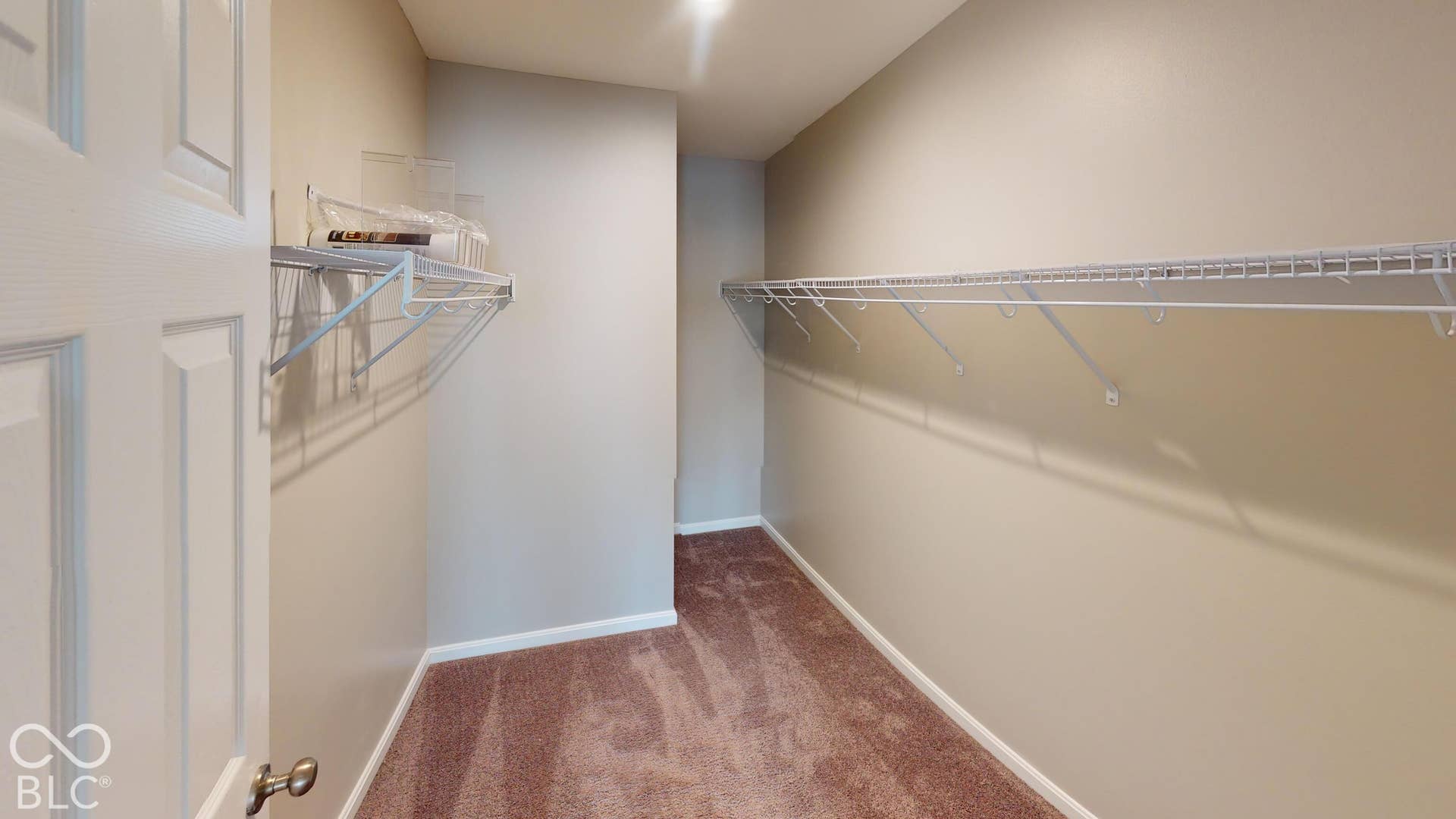 Primary Bedroom's Walk-in closet featuring wire shelving and neutral-toned carpeting (Part of Bedroom #3)