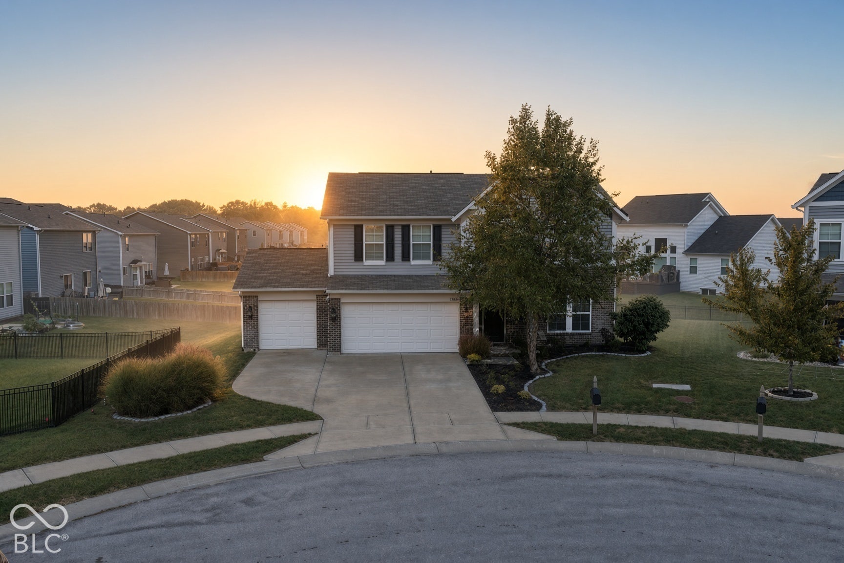 Virtually Altered - *AI - Sunrise Conversion* Two-story residence with gray siding and brick accents