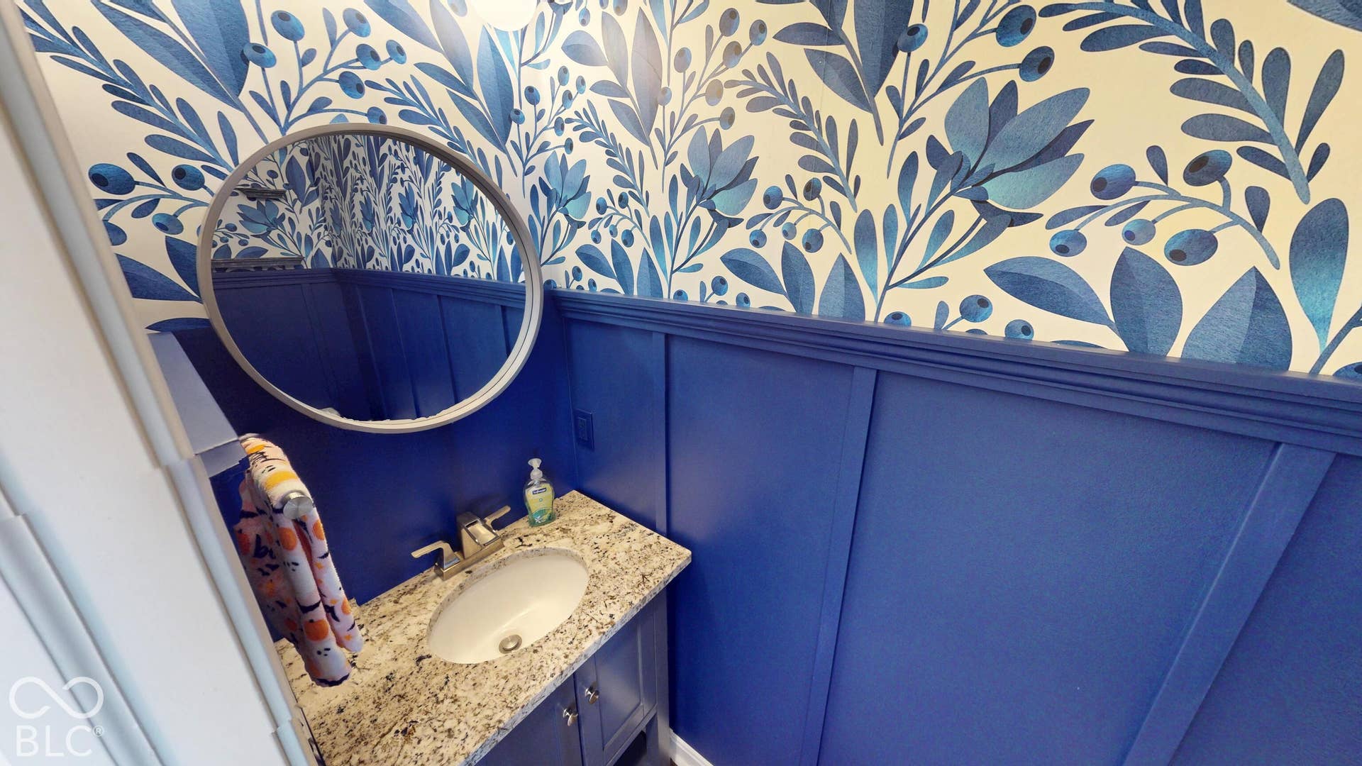 Blue board-and-batten wainscoting with a decorative top trim | Half Bathroom