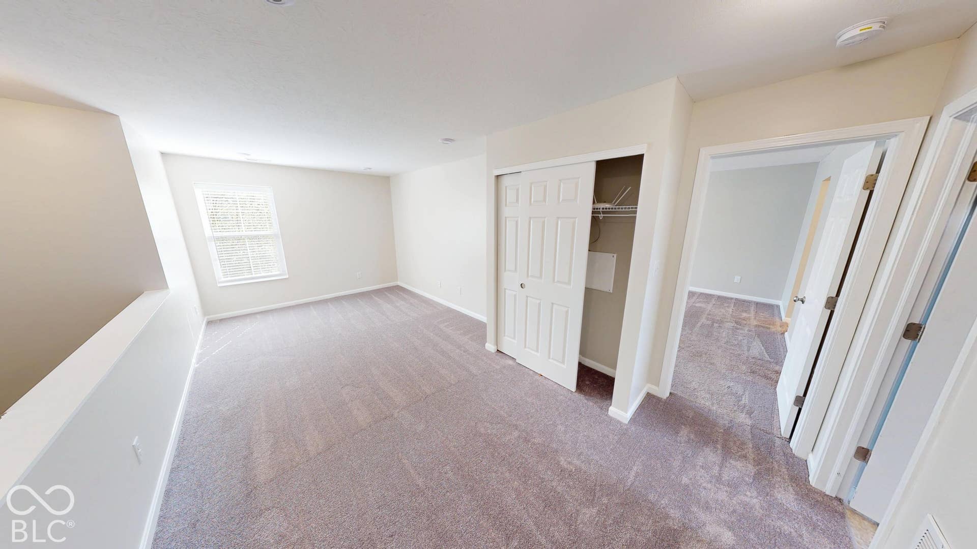 Carpeted room featuring a double window, recessed lighting, and a sliding closet