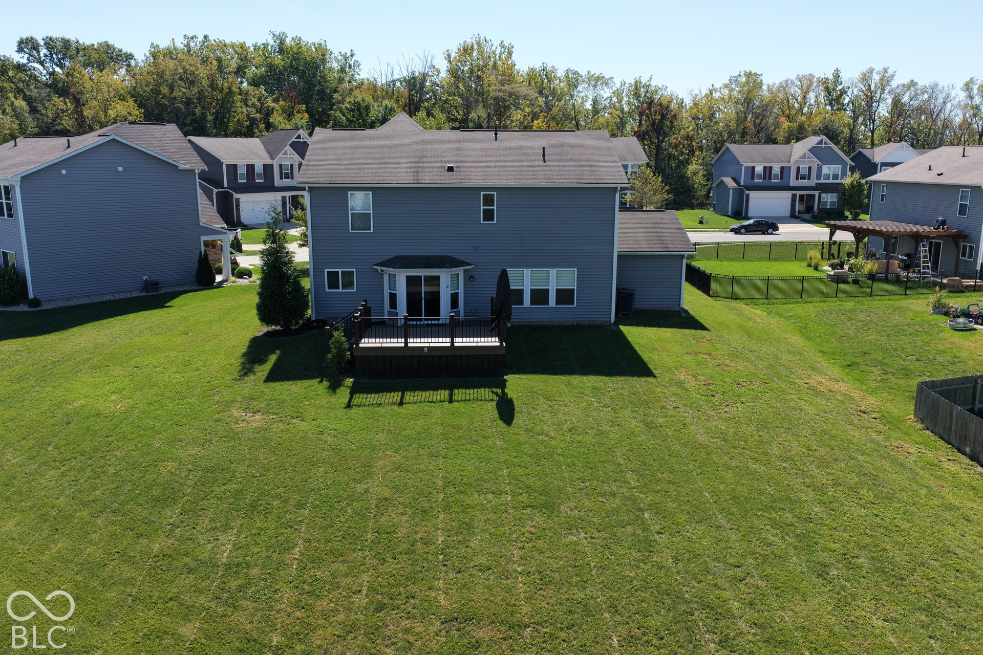 *Unaltered Exterior Stills* Expansive rear lawn, multi-level decking, and a sliding glass door