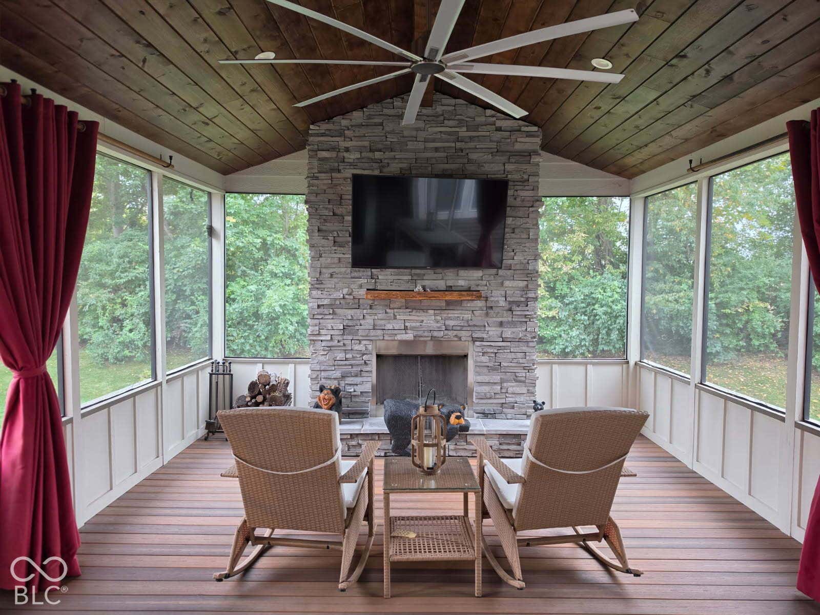 5579 W Turnbuckle Place, McCordsville, IN 46055 This beautiful screened porch offers weather-resistant flooring, a wood ceiling, a large ceiling fan, stone wood-burning fireplace, TV, surround sound, private view. Priceless!