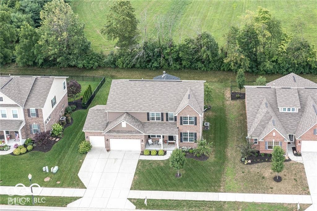 5579 W Turnbuckle Place, McCordsville, IN 46055 Tree lined-back yard and a farm field behind the home for added privacy.