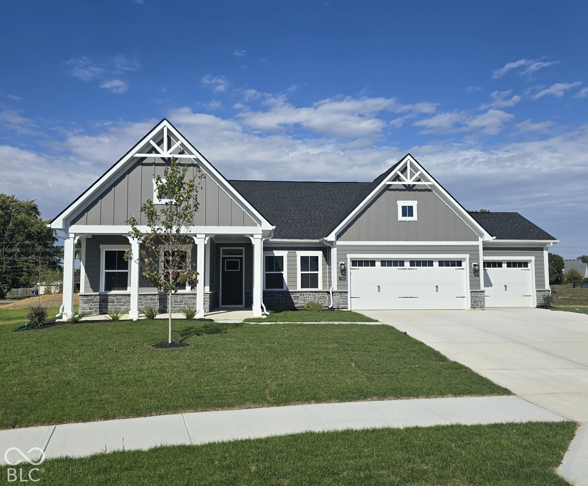 Craftsman-style exterior with gabled roof lines and decorative trusses