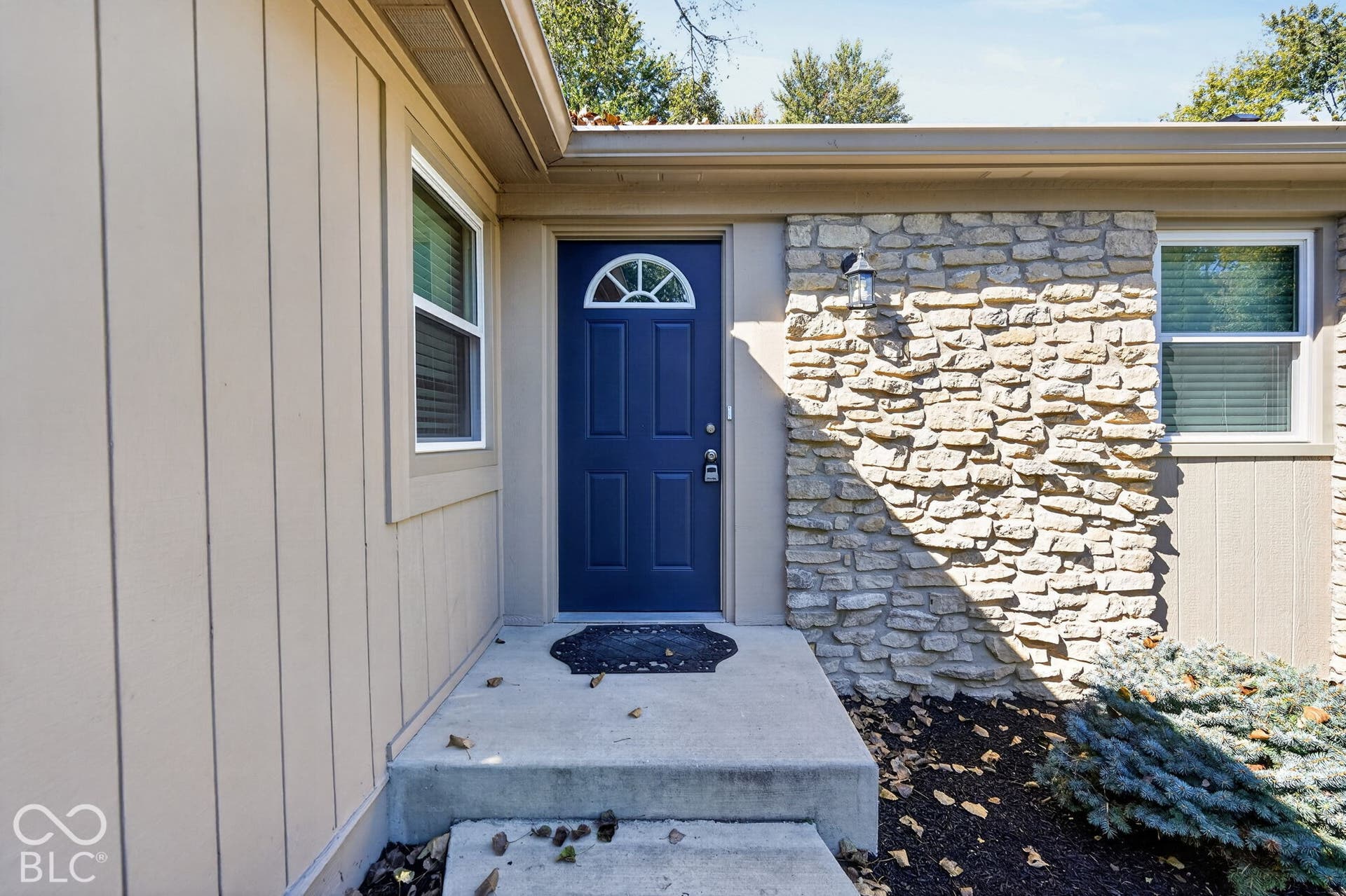 Stone accent facade with vertical siding