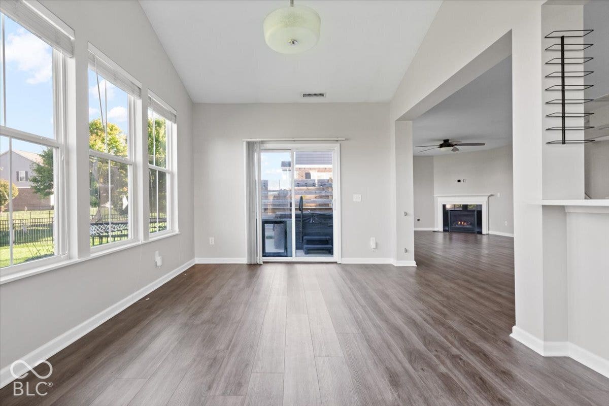 5570 W Stream Drive, McCordsville, IN 46055 Wood-finish flooring throughout, multiple windows, and a sliding glass door