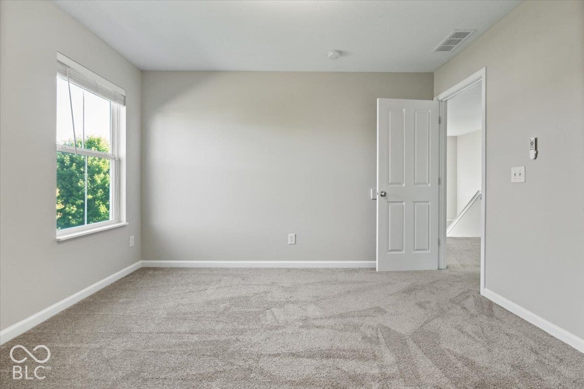 5570 W Stream Drive, McCordsville, IN 46055 Window with a white frame, light gray wall finishes, and gray carpet flooring