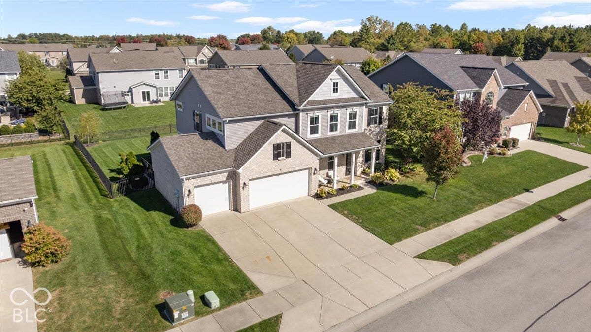 5570 W Stream Drive, McCordsville, IN 46055 Two-story residence featuring light gray siding and brick accents