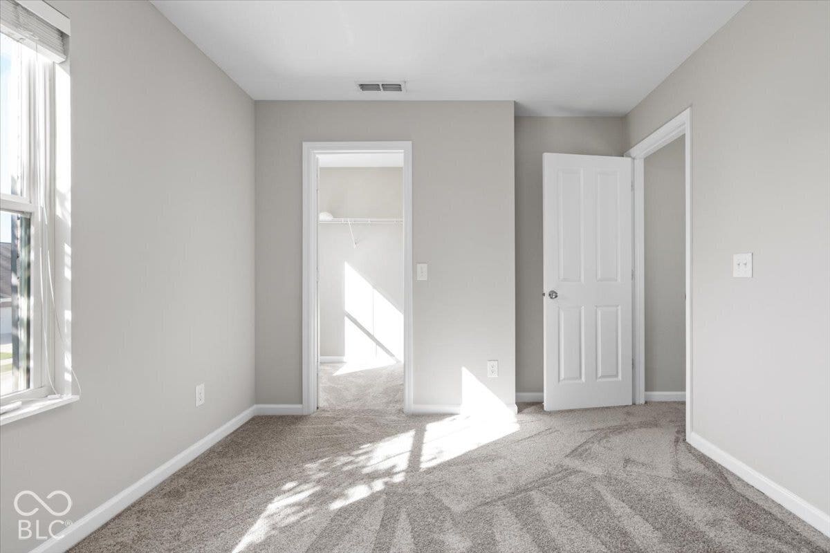 5570 W Stream Drive, McCordsville, IN 46055 Carpeted flooring, neutral wall tones, white trim, window with blinds, and a paneled door