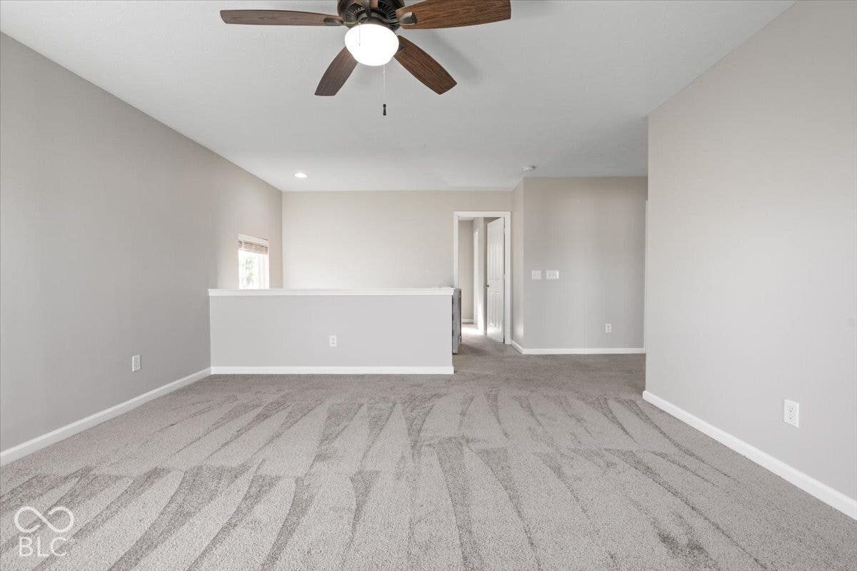 5570 W Stream Drive, McCordsville, IN 46055 Carpeted upper-level space featuring a ceiling fan with integrated lighting, recessed lighting, neutral wall tones, and a window for natural light