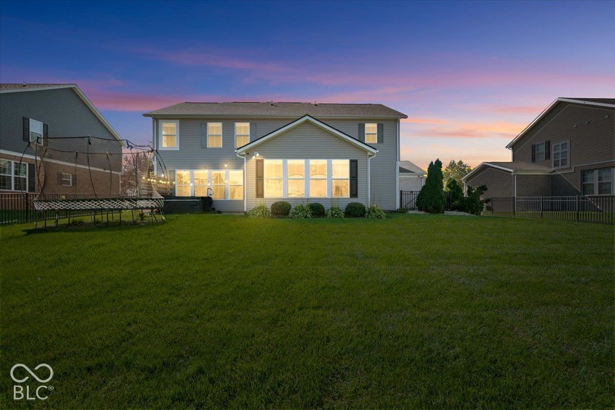 5570 W Stream Drive, McCordsville, IN 46055 Expansive green lawn with a two-story residence featuring light-colored siding and dark shutters