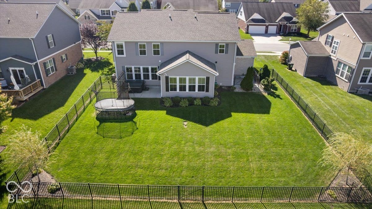 5570 W Stream Drive, McCordsville, IN 46055 Expansive backyard featuring a manicured lawn, full perimeter fencing, and a concrete patio
