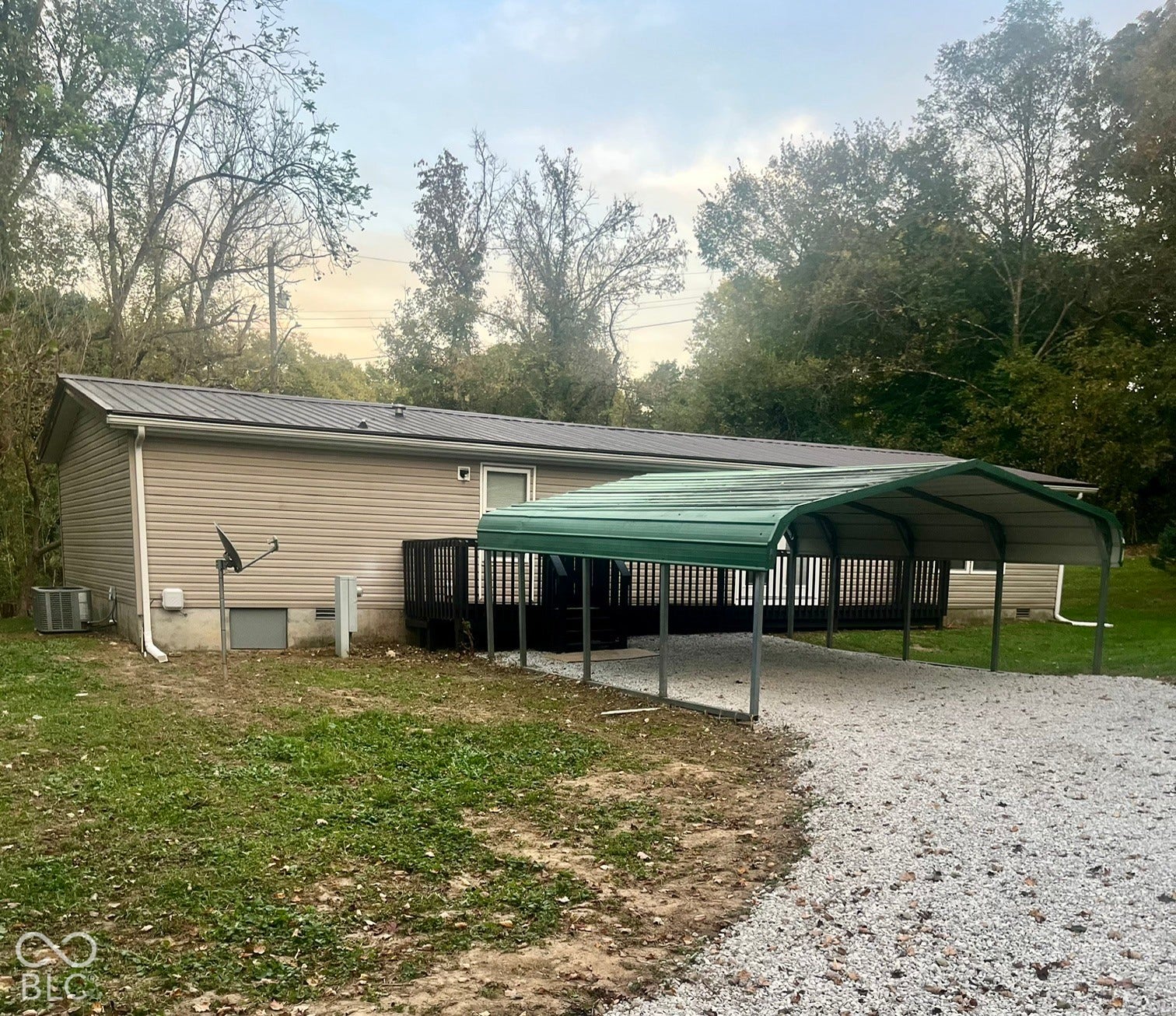 Siding exterior with a metal roof and an outdoor deck
