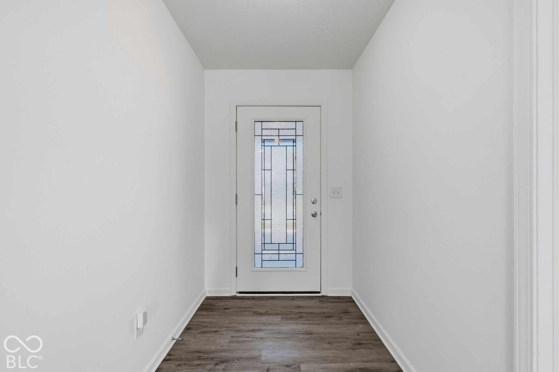 10525 Broadford Street, Indianapolis, IN 46239 Entryway featuring wood-finish flooring and a white door with decorative glass inserts