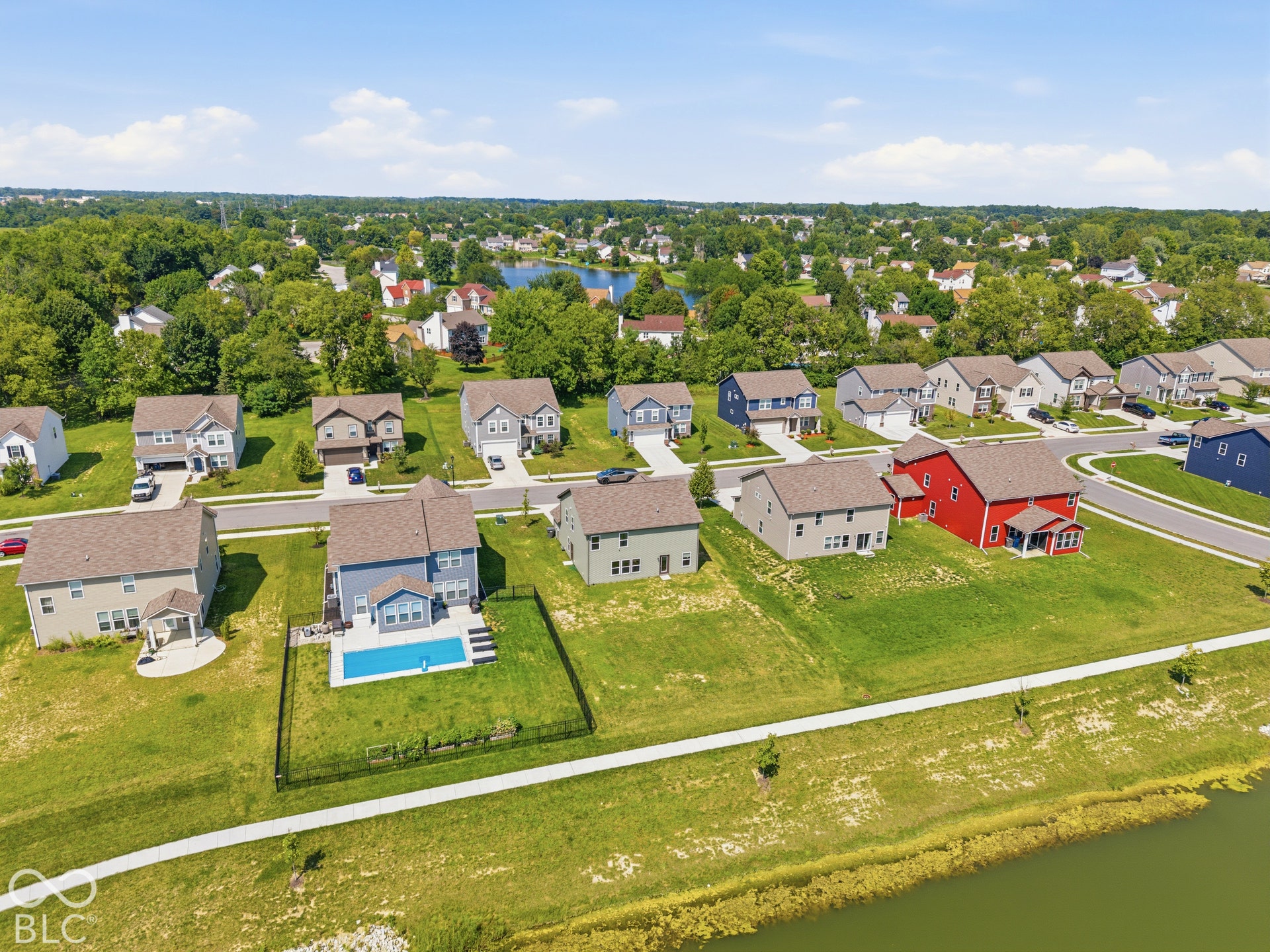 10525 Broadford Street, Indianapolis, IN 46239 Residential area featuring multiple single-family homes with varied exterior colors, paved streets, and green spaces