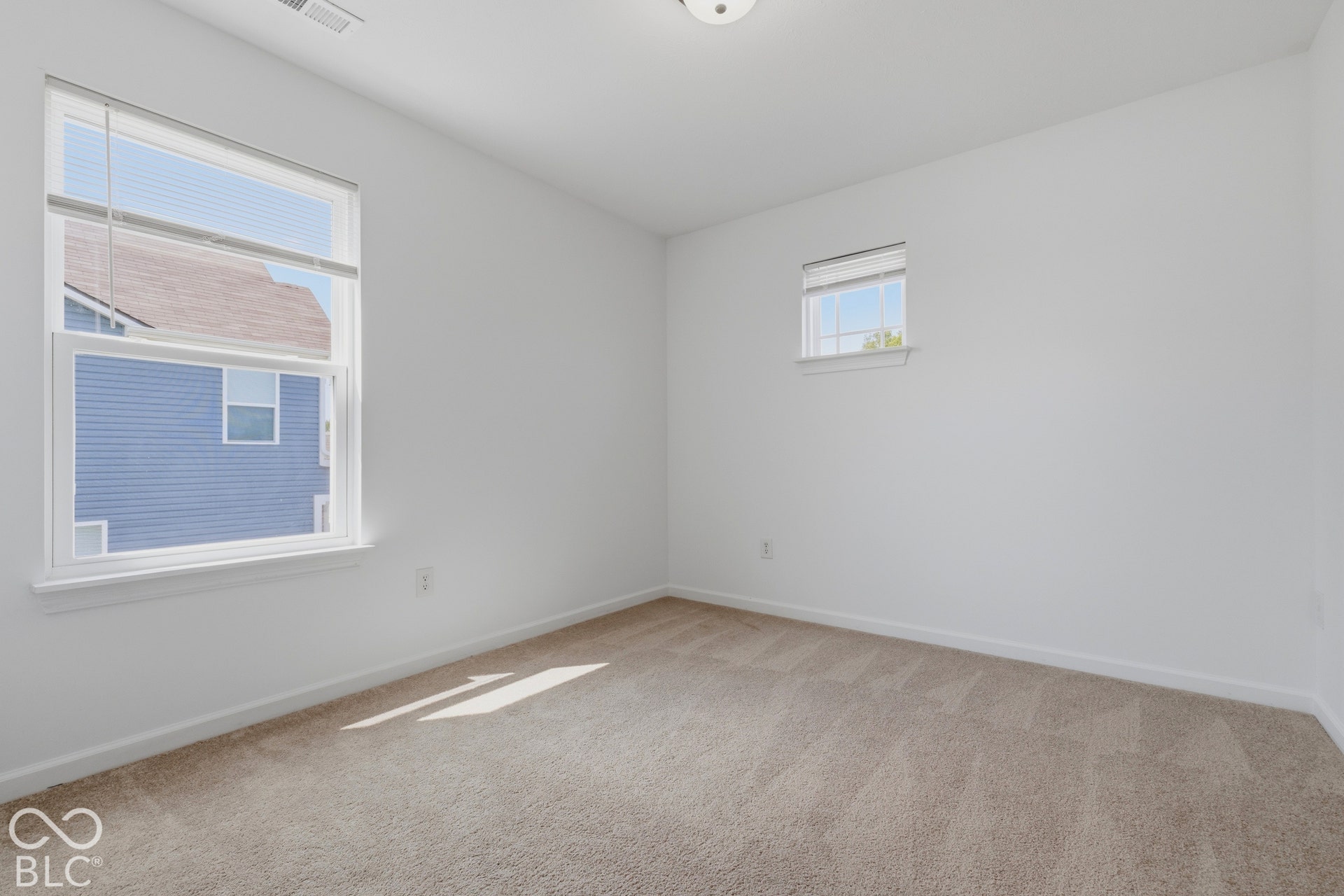 10525 Broadford Street, Indianapolis, IN 46239 Neutral wall paint, carpet flooring, and multiple windows