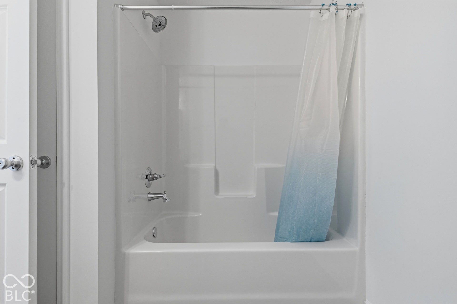 10525 Broadford Street, Indianapolis, IN 46239 White fiberglass tub and shower combination with chrome fixtures