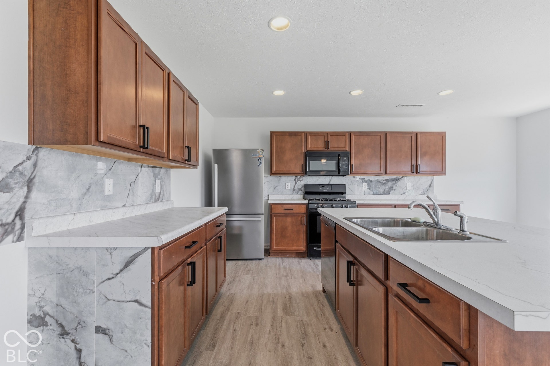 10525 Broadford Street, Indianapolis, IN 46239 Kitchen featuring warm wood-finish cabinetry, light-toned countertops, and a full stainless steel appliance package