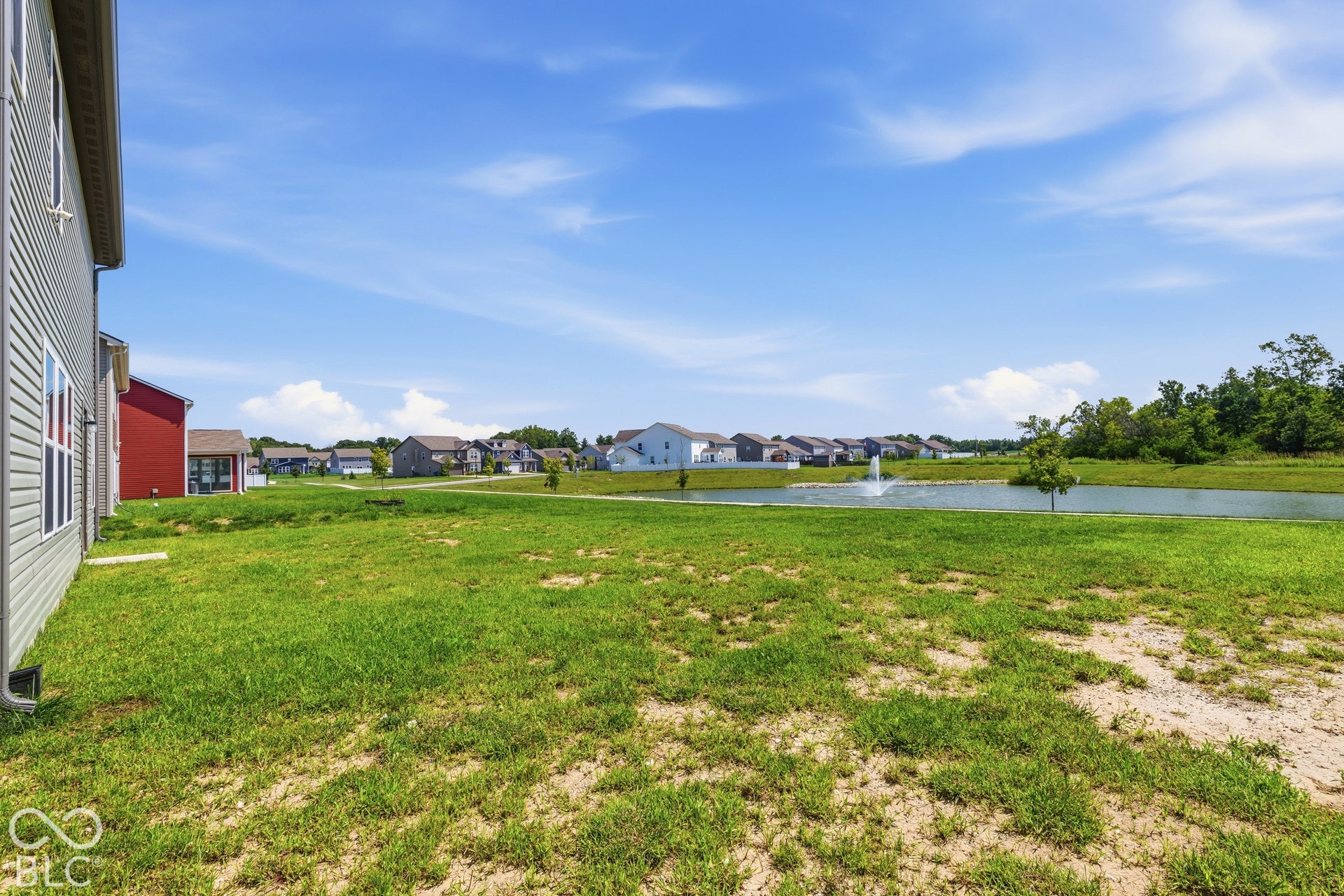 10525 Broadford Street, Indianapolis, IN 46239 Expansive grassy area with a visible pond and fountain