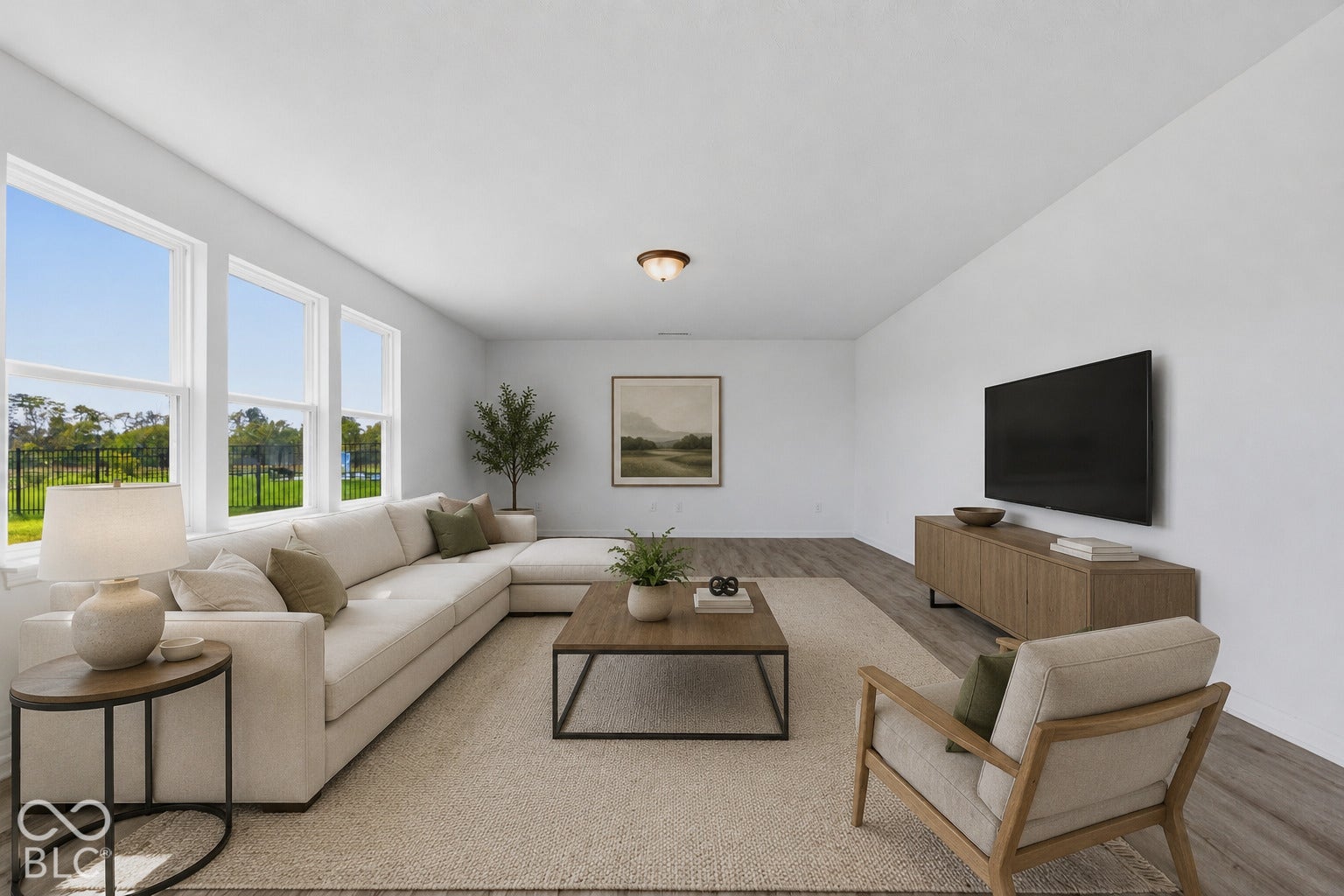 10525 Broadford Street, Indianapolis, IN 46239 Virtually Altered - Spacious living area featuring abundant natural light, light wood-finish flooring, and crisp white walls