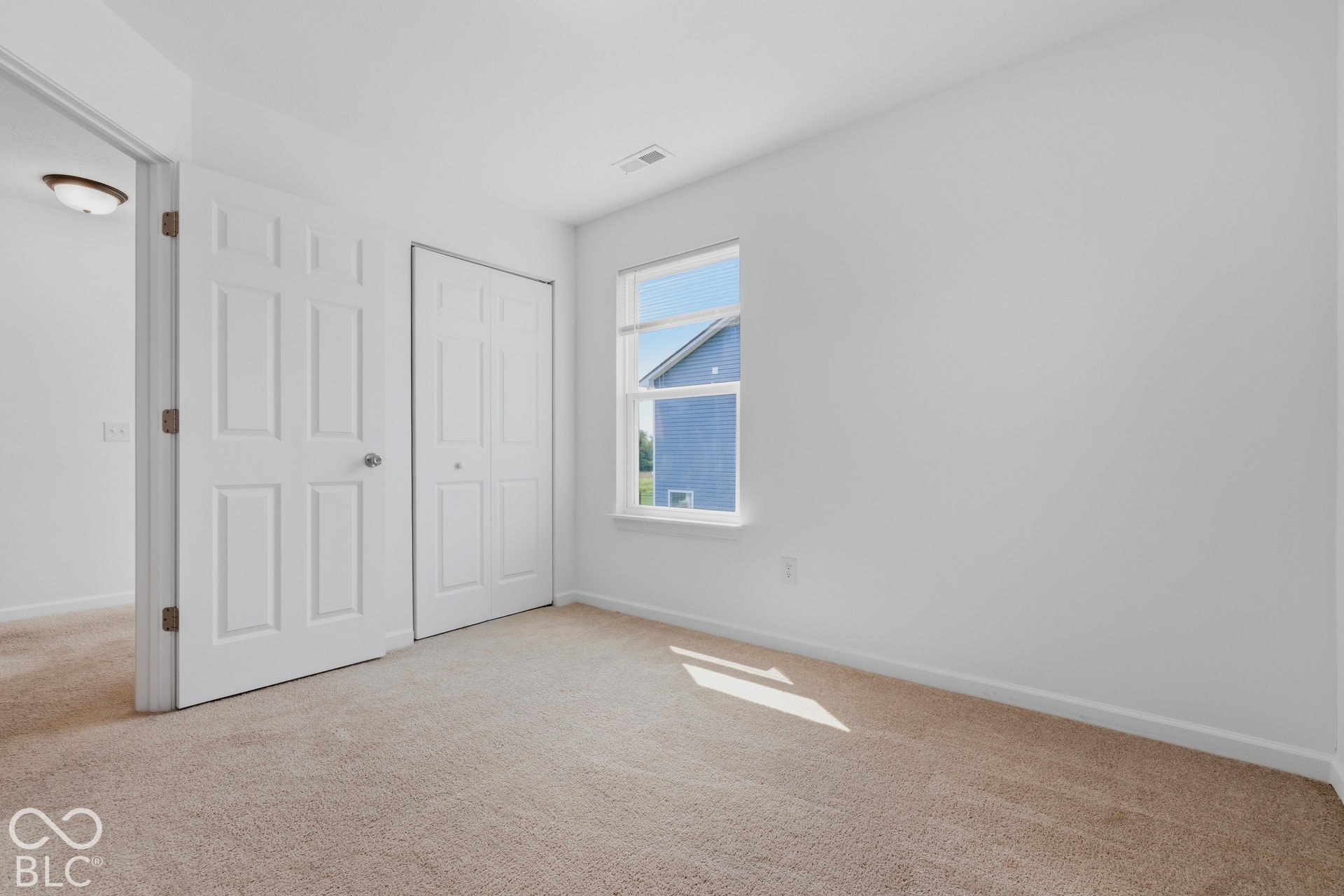10525 Broadford Street, Indianapolis, IN 46239 Neutral tone wall color, plush carpet flooring, and a single window with white trim