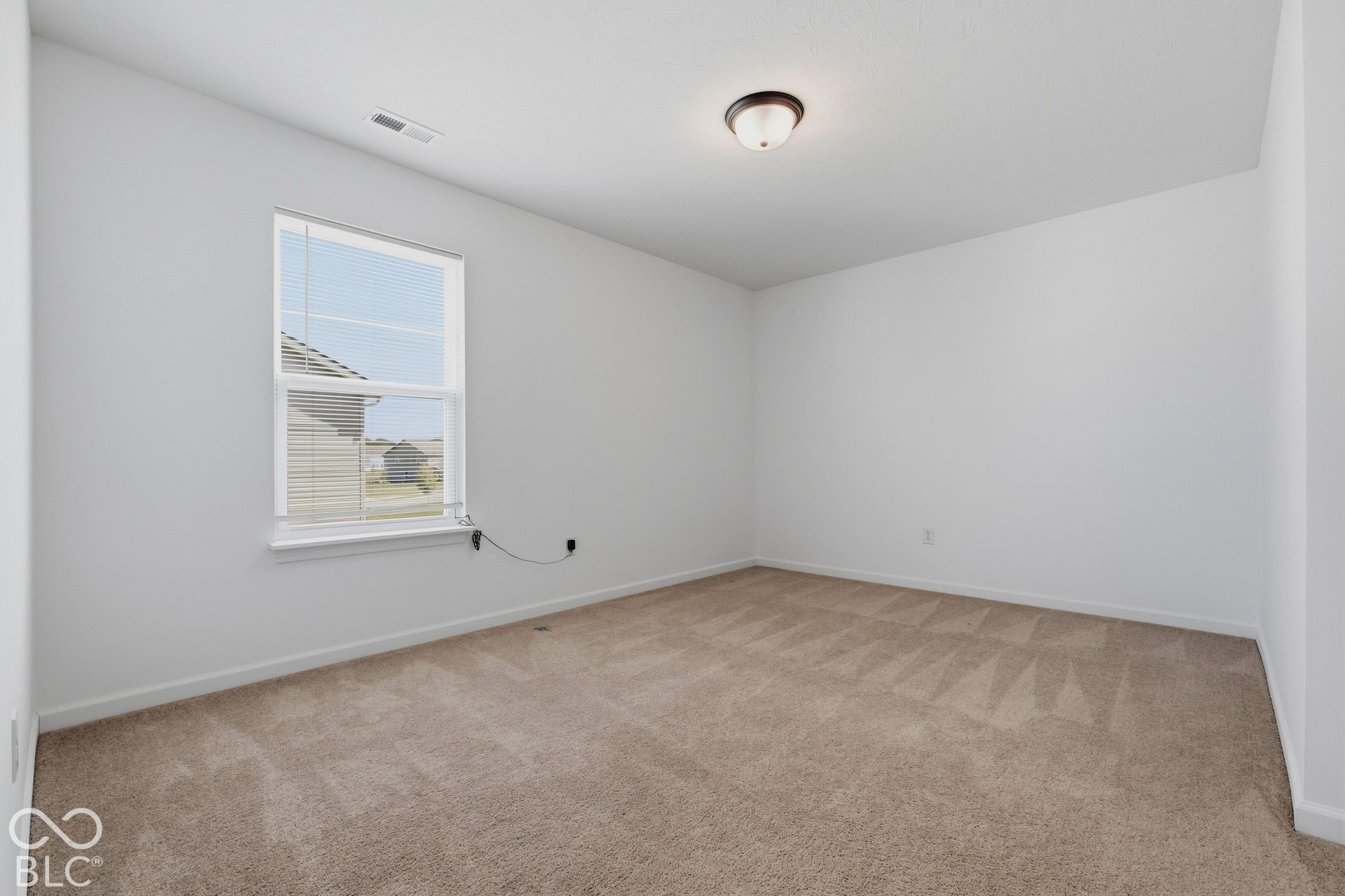10525 Broadford Street, Indianapolis, IN 46239 Neutral wall finishes with a single window, overhead flush-mount lighting, and carpeted flooring