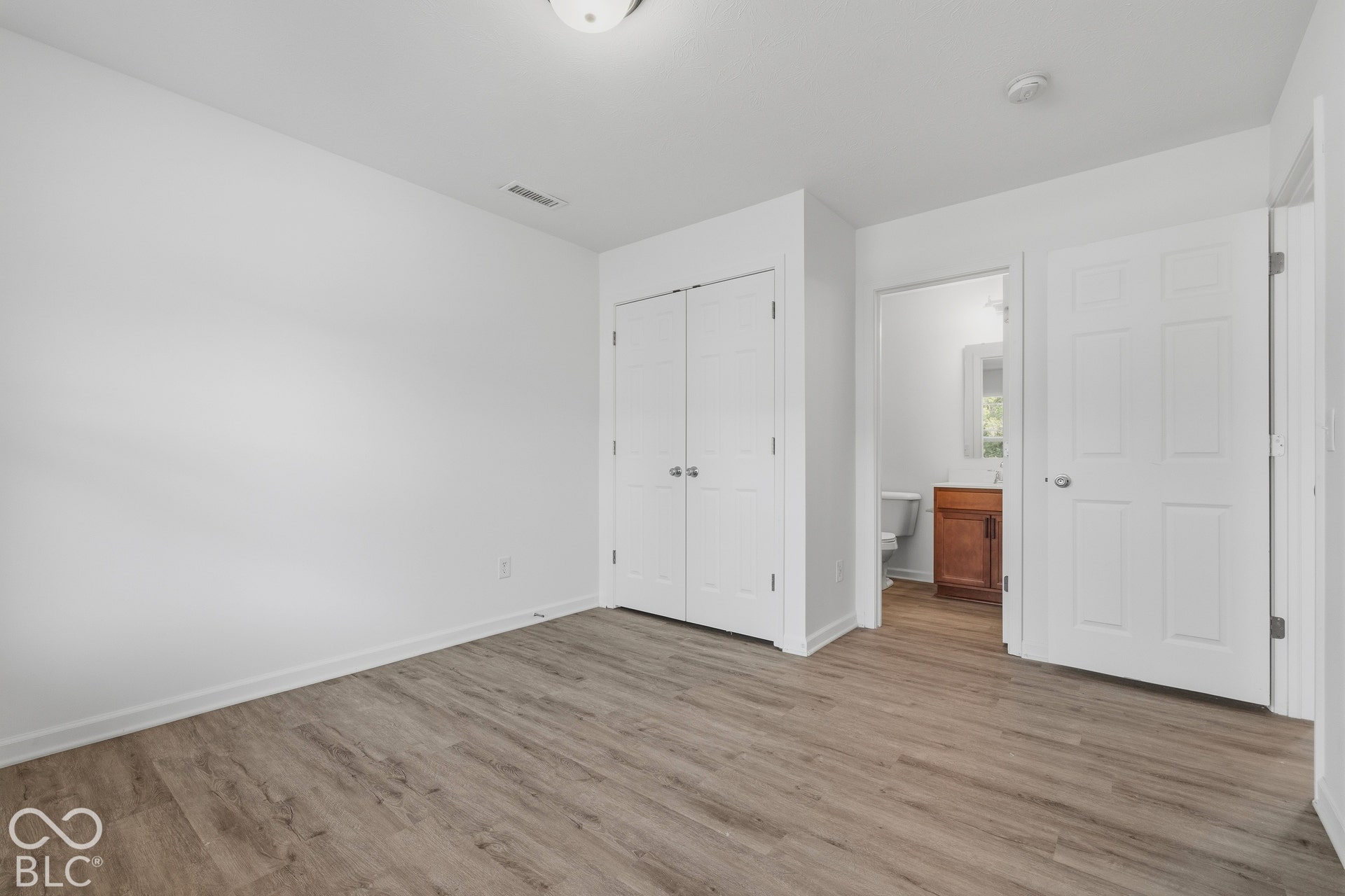 10525 Broadford Street, Indianapolis, IN 46239 Wood-finish flooring, white walls, and a ceiling-mounted light fixture