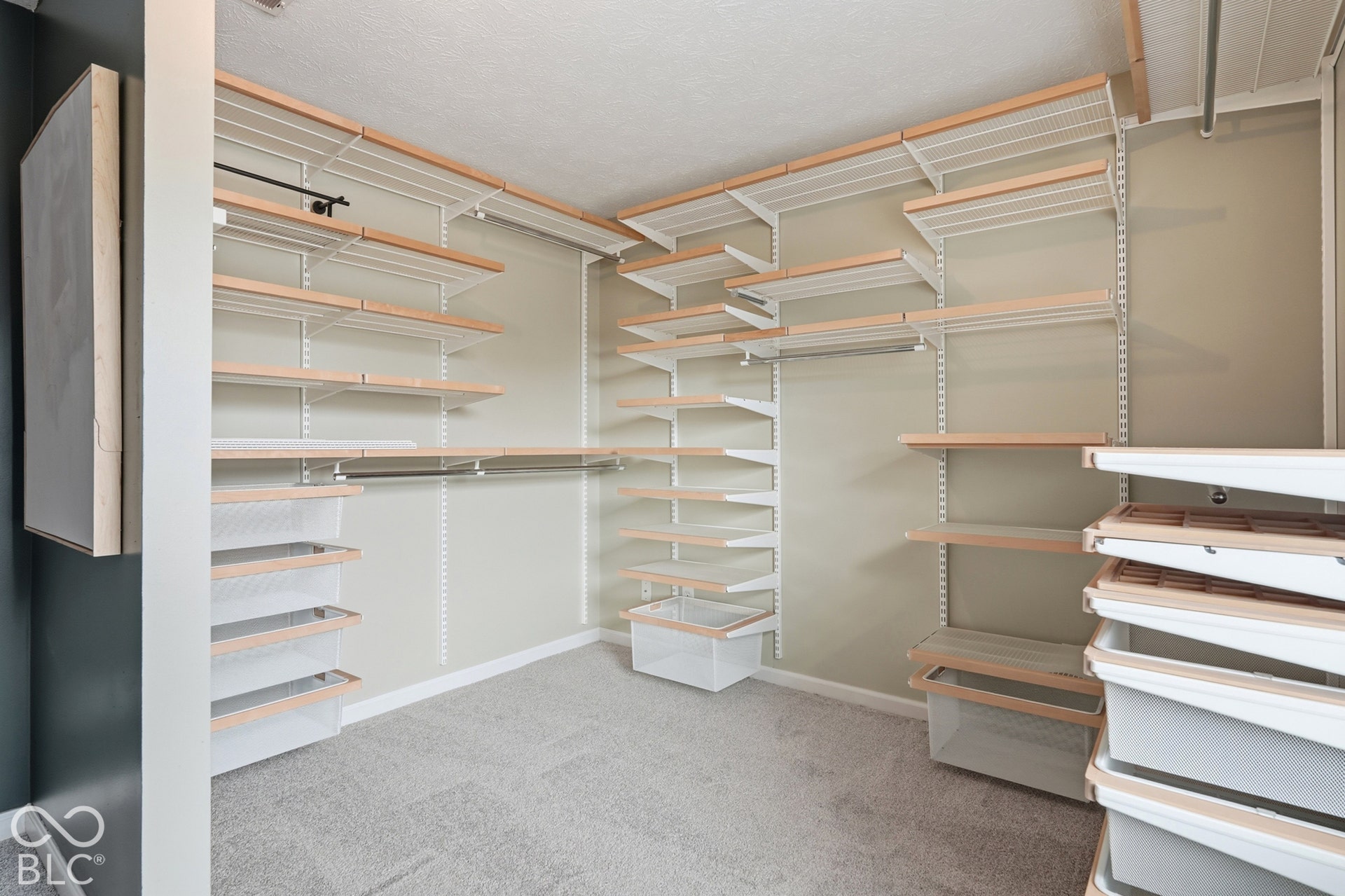 Customizable closet system featuring adjustable shelving, integrated hanging rods, and pull-out storage bins