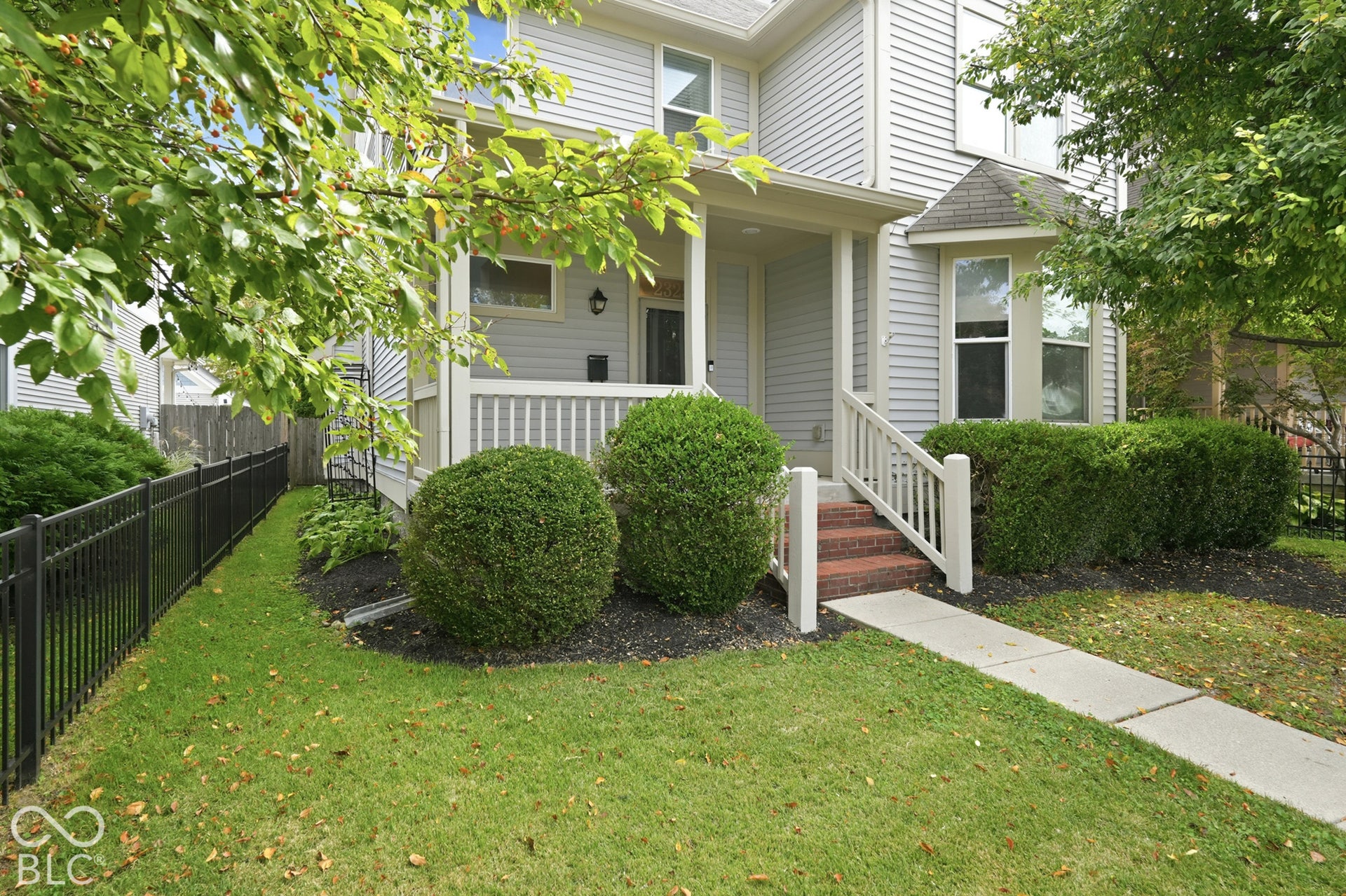 Front exterior featuring light-colored siding and a covered porch