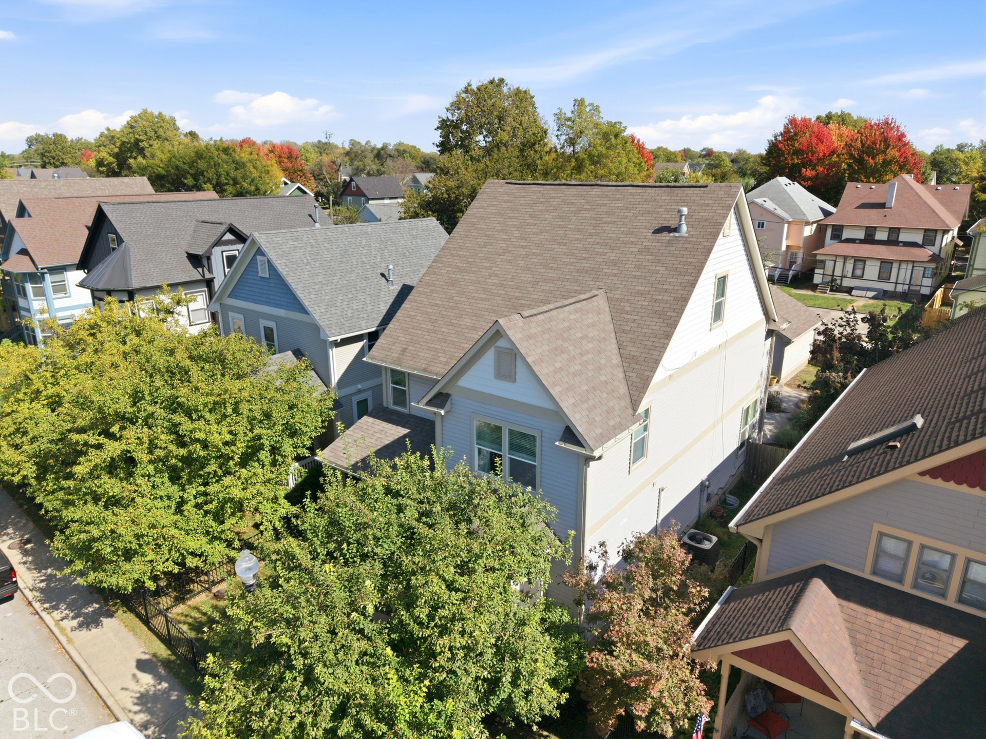 Two-story residence with light-colored siding and a gabled roofline