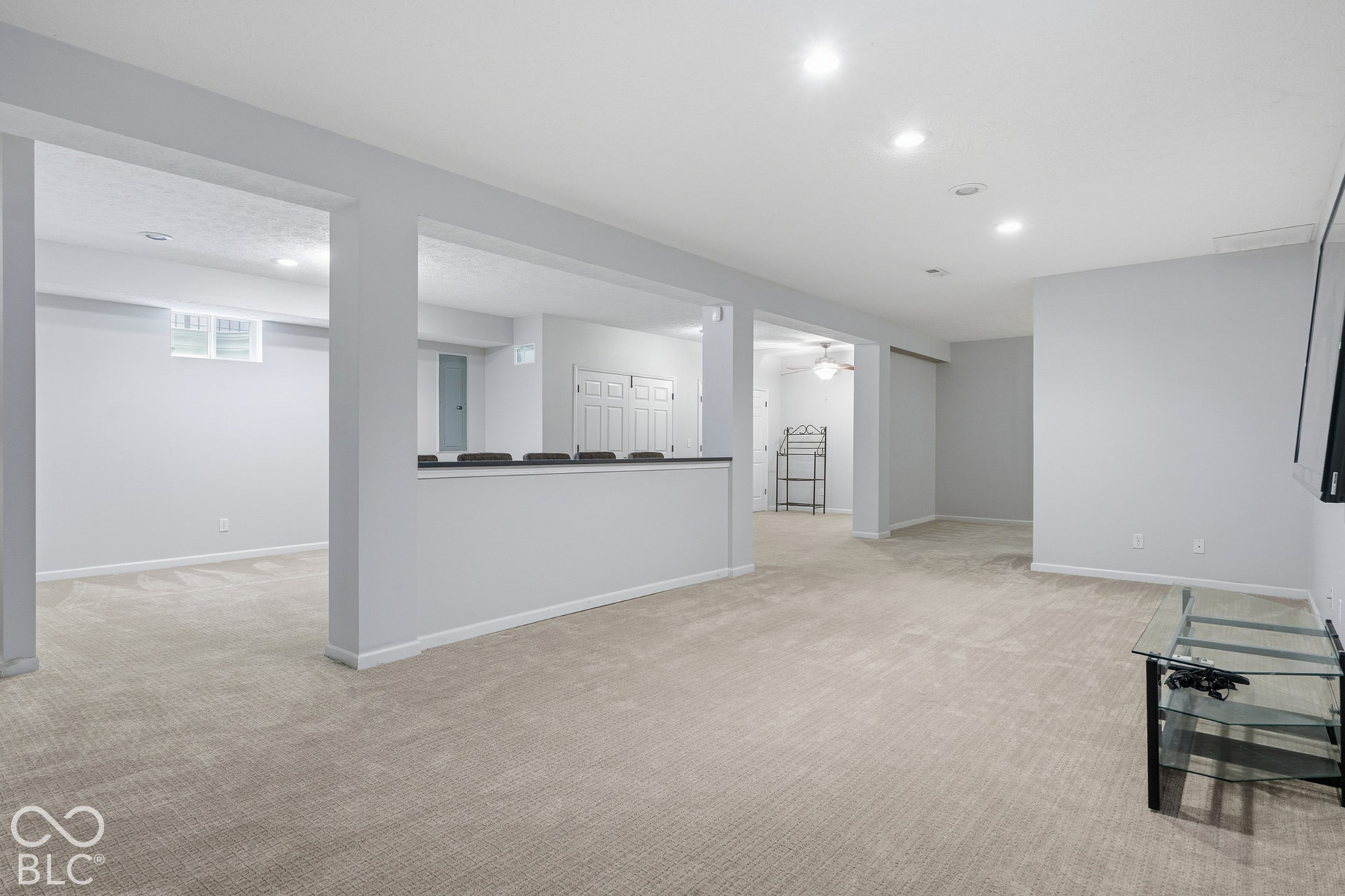 Expansive finished lower level featuring recessed lighting and neutral carpeting