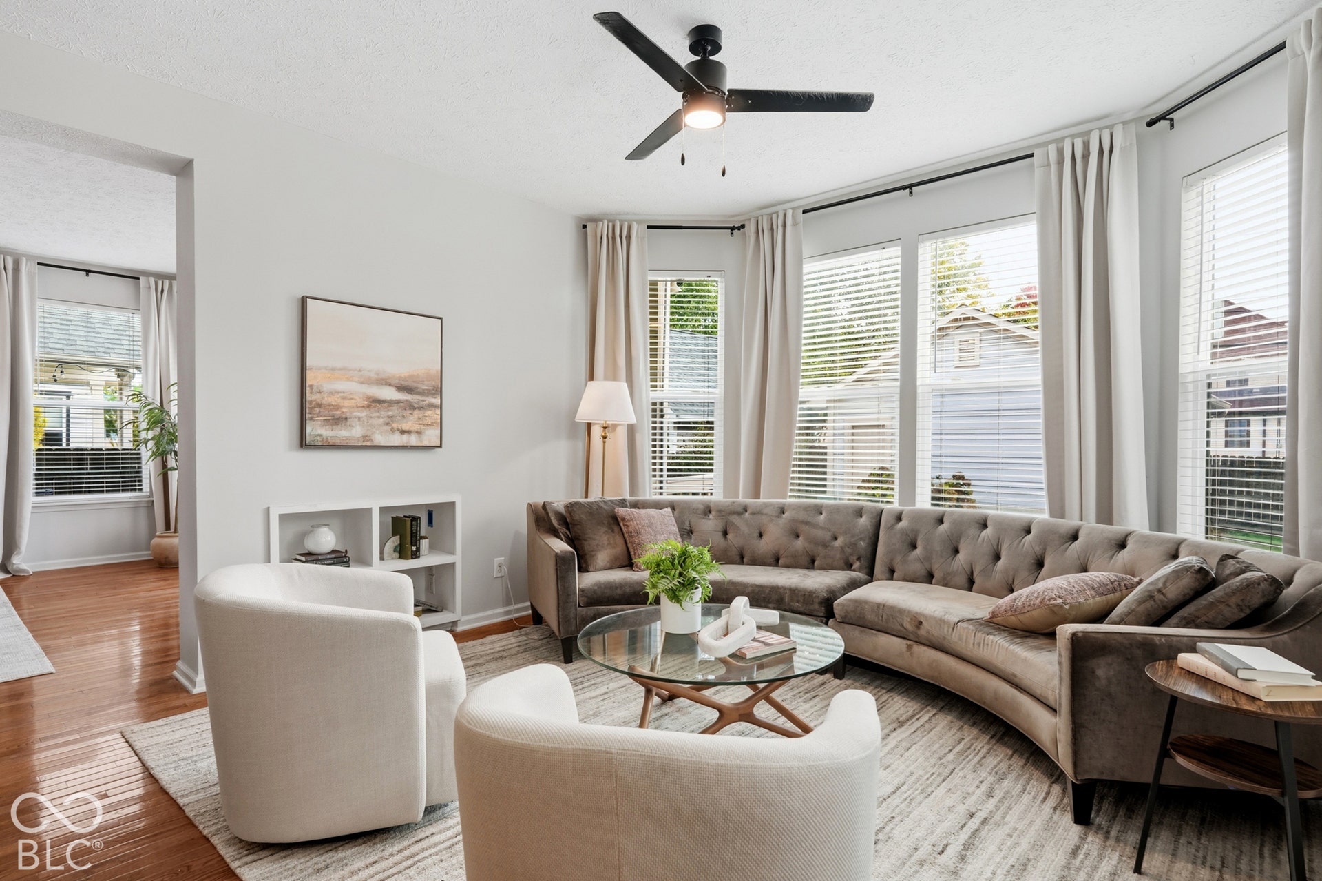 Recessed lighting, ceiling fan, multiple windows with blinds, and wood-finish flooring