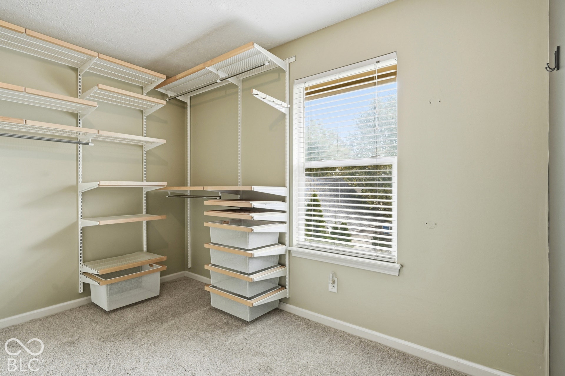 Integrated custom closet system with multiple shelving units and drawers