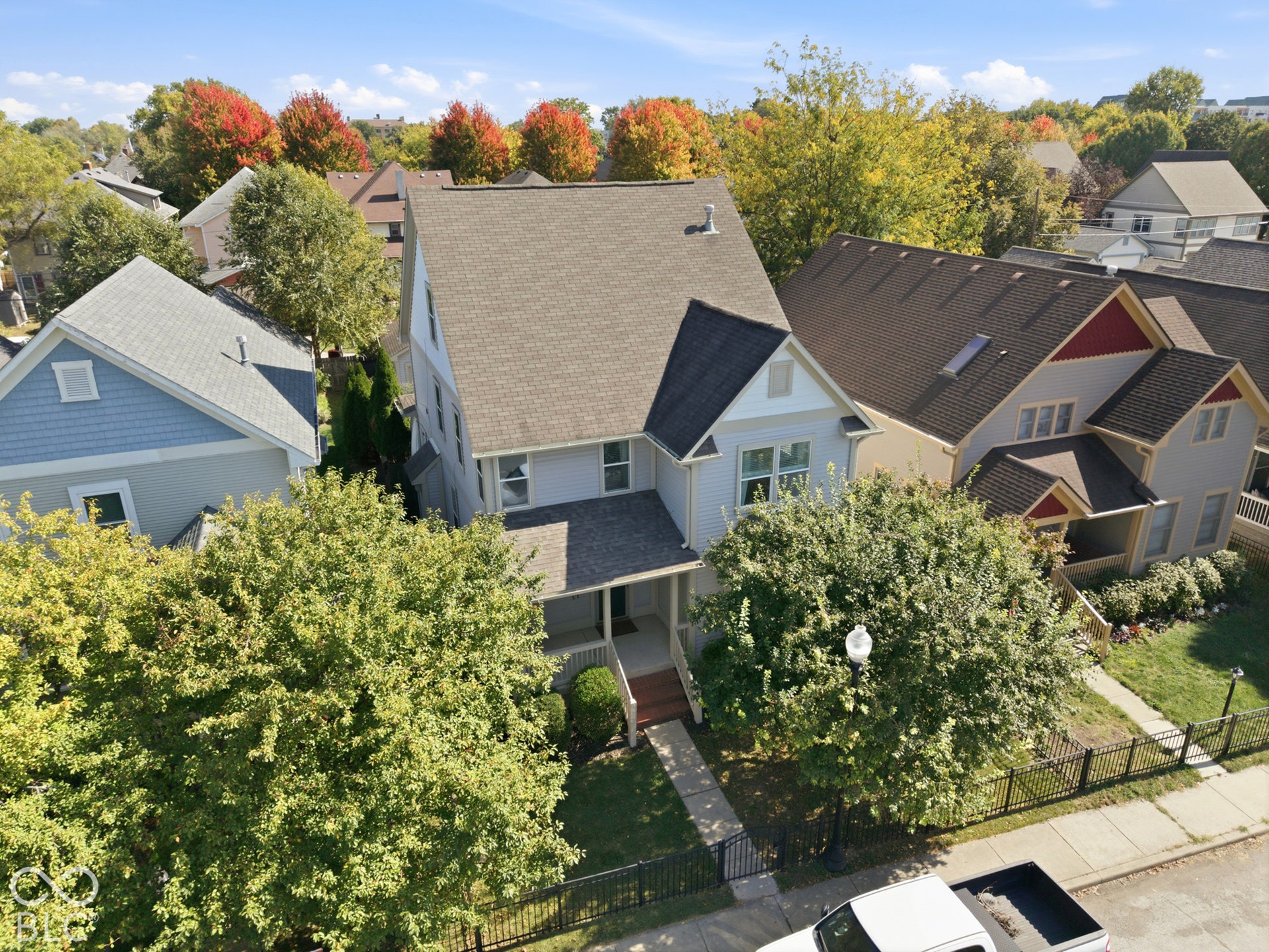 Two-story residence with a covered front porch and a picket fence
