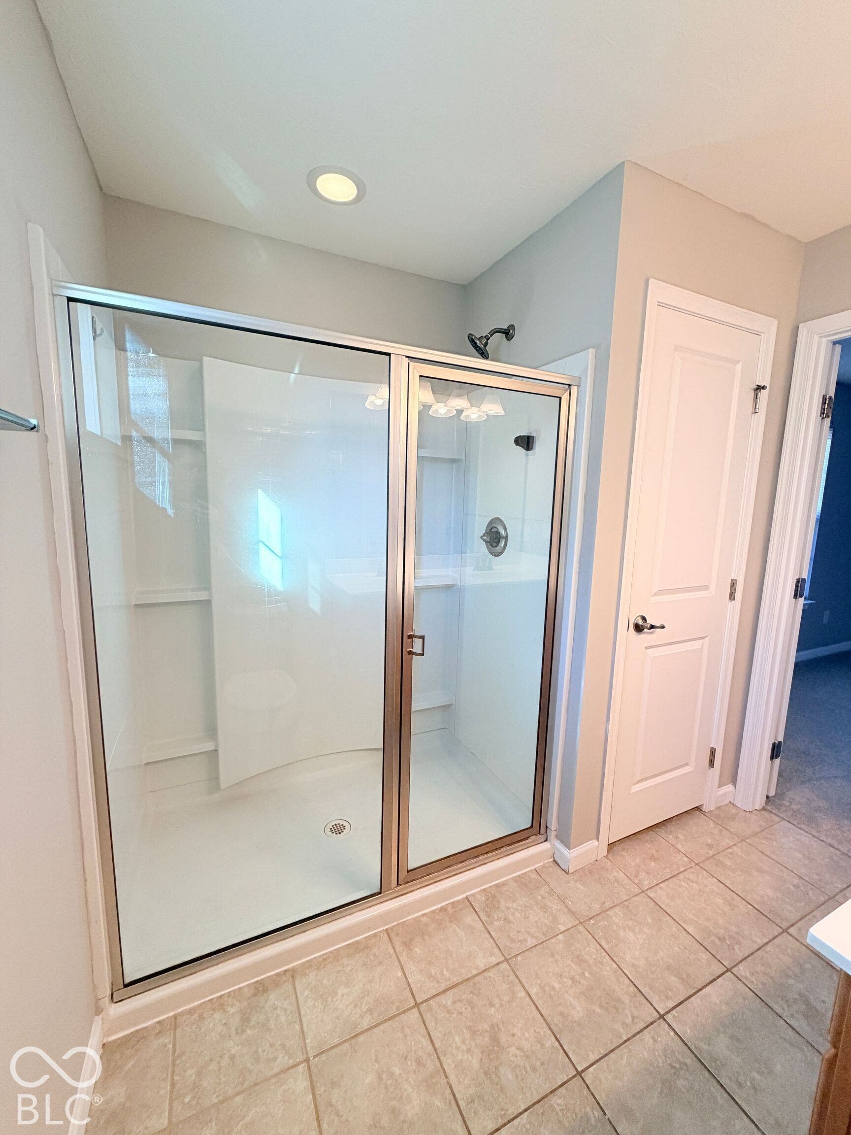 652 Classic Lane, Greenwood, IN 46143 Glass-enclosed shower with a bronze-toned frame, recessed lighting, and a white shower surround