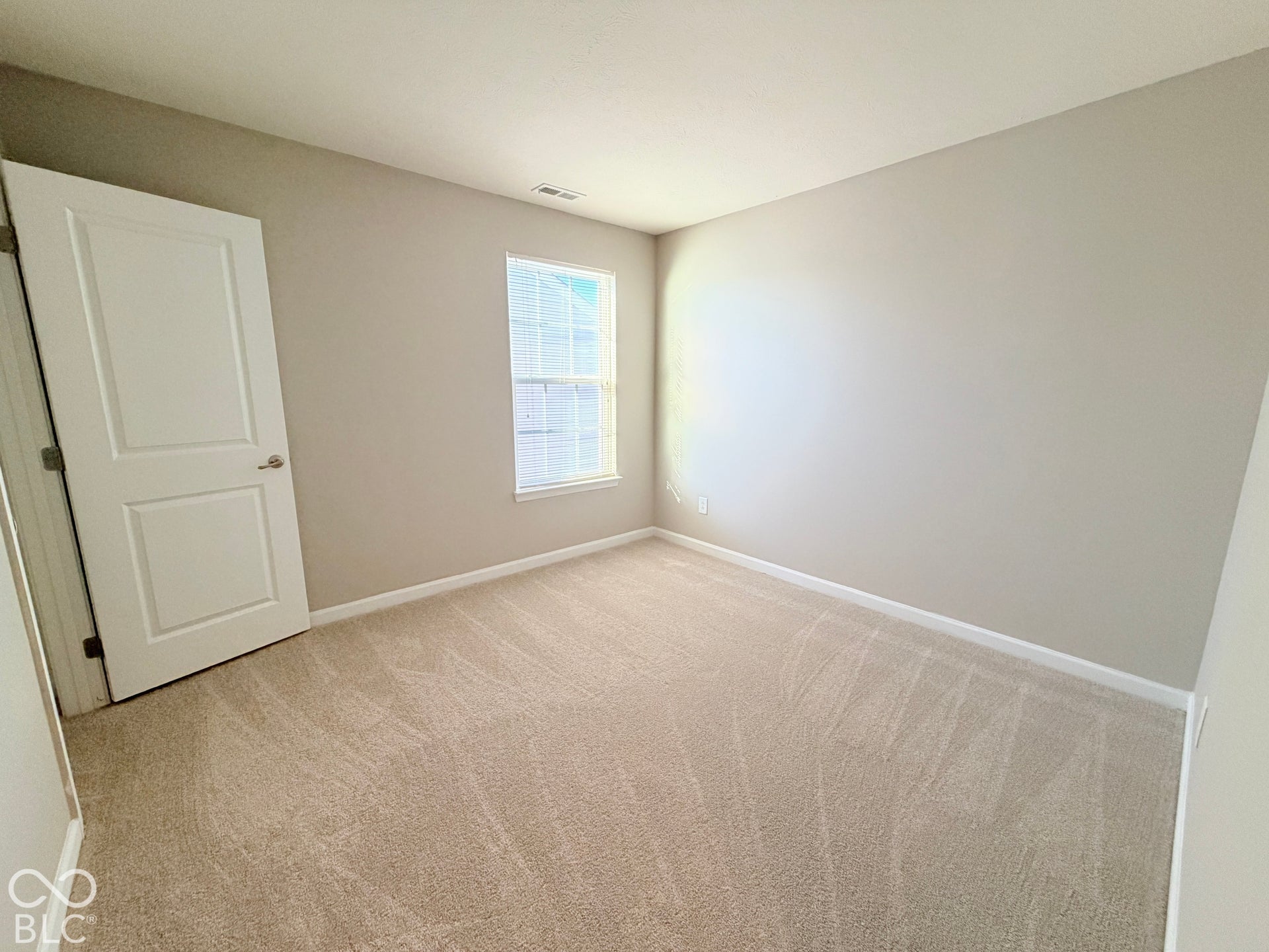 652 Classic Lane, Greenwood, IN 46143 Neutral wall color, carpeted flooring, window with horizontal blinds, and a white interior door
