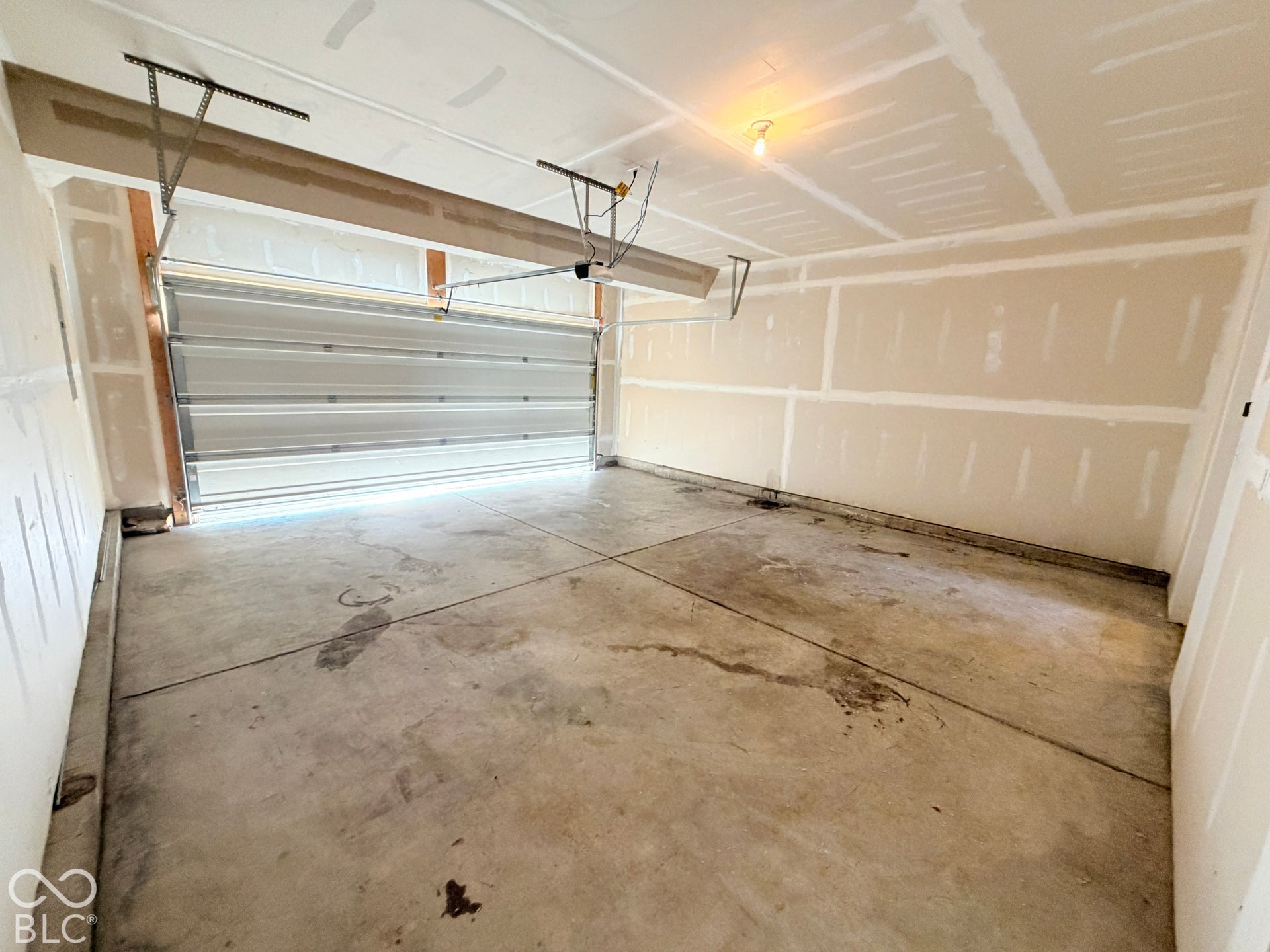 652 Classic Lane, Greenwood, IN 46143 Attached garage featuring a concrete floor and drywall-finished walls