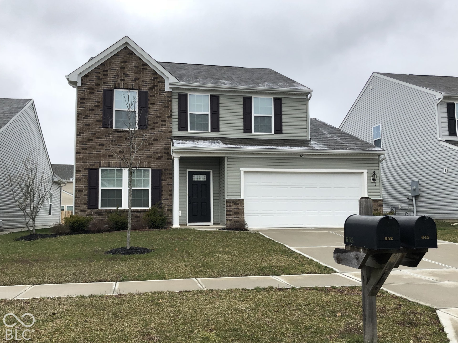 652 Classic Lane, Greenwood, IN 46143 Two-story residence featuring brick and siding facade, an attached two-car garage, and a concrete driveway