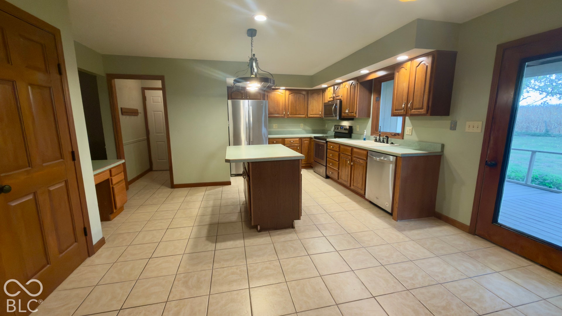 4034 W State Road 135 W, Trafalgar, IN 46181 Kitchen featuring a central island, tile flooring, wood cabinetry, and stainless steel appliances