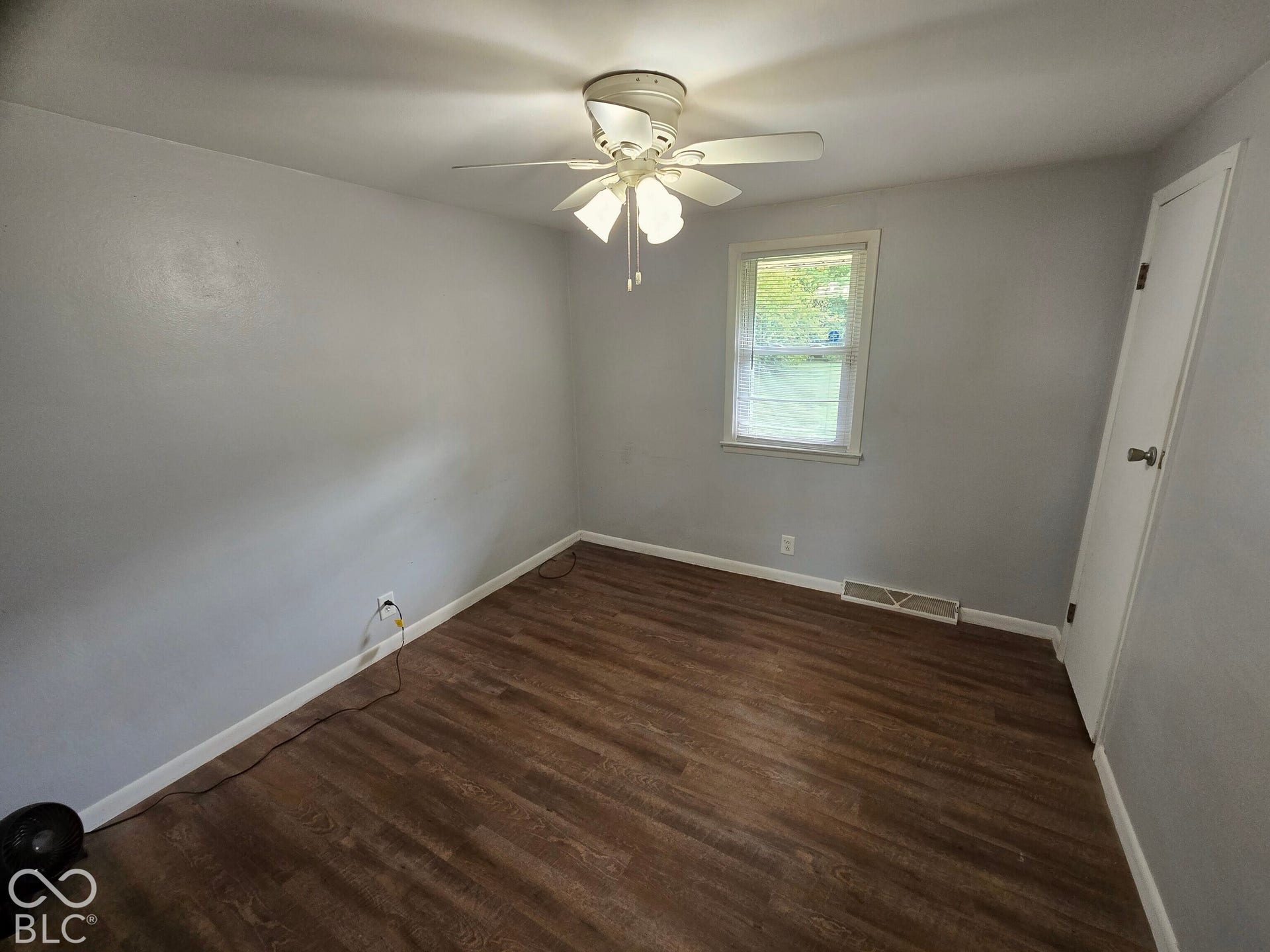 6720 S County Road 800 W, Daleville, IN 47334 Virtually Altered - Wood-finish flooring, light grey walls, white trim, and a ceiling fan with integrated lighting