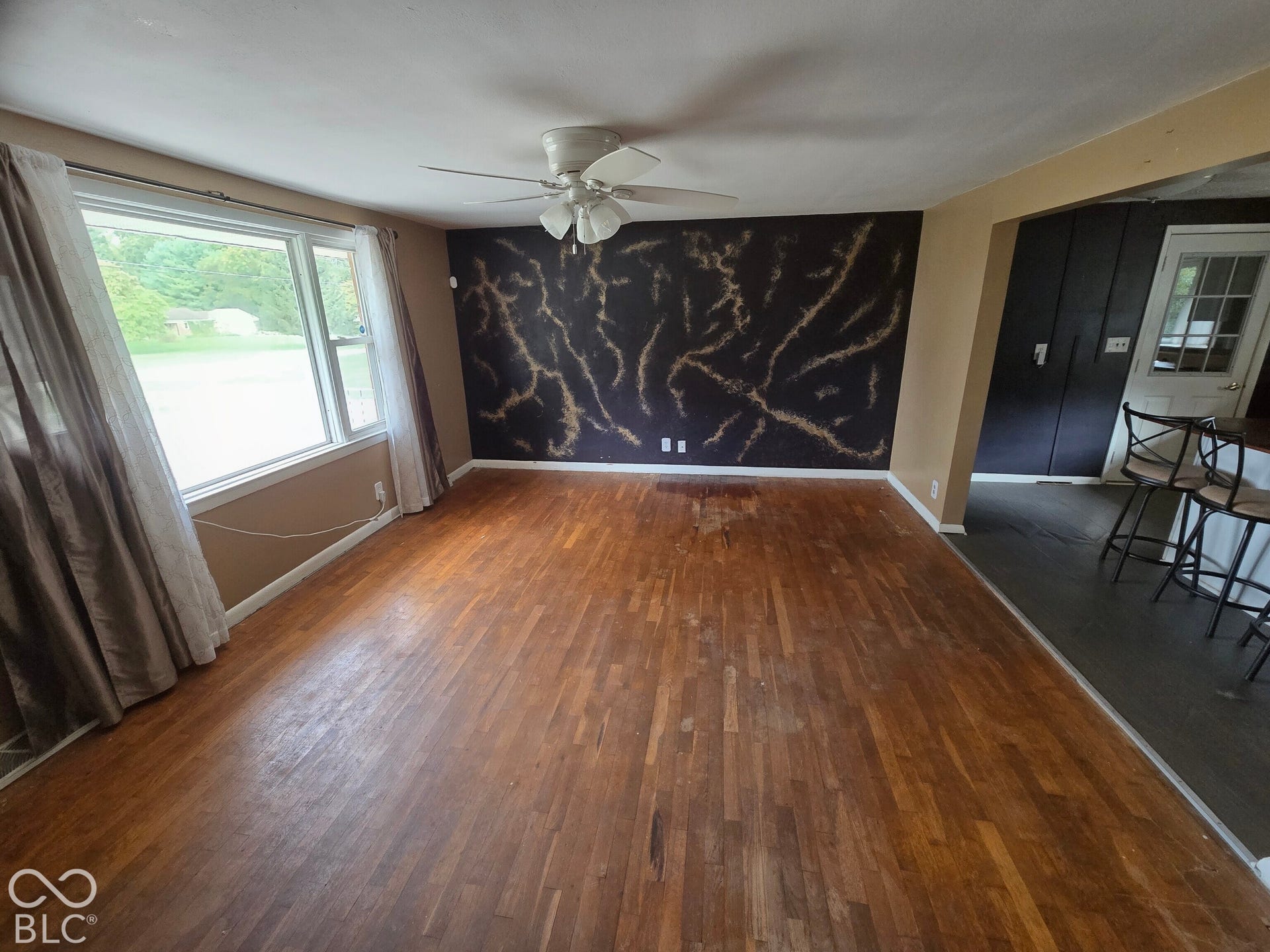 6720 S County Road 800 W, Daleville, IN 47334 Wood-finish flooring throughout, ceiling fan, and large window with outdoor visibility