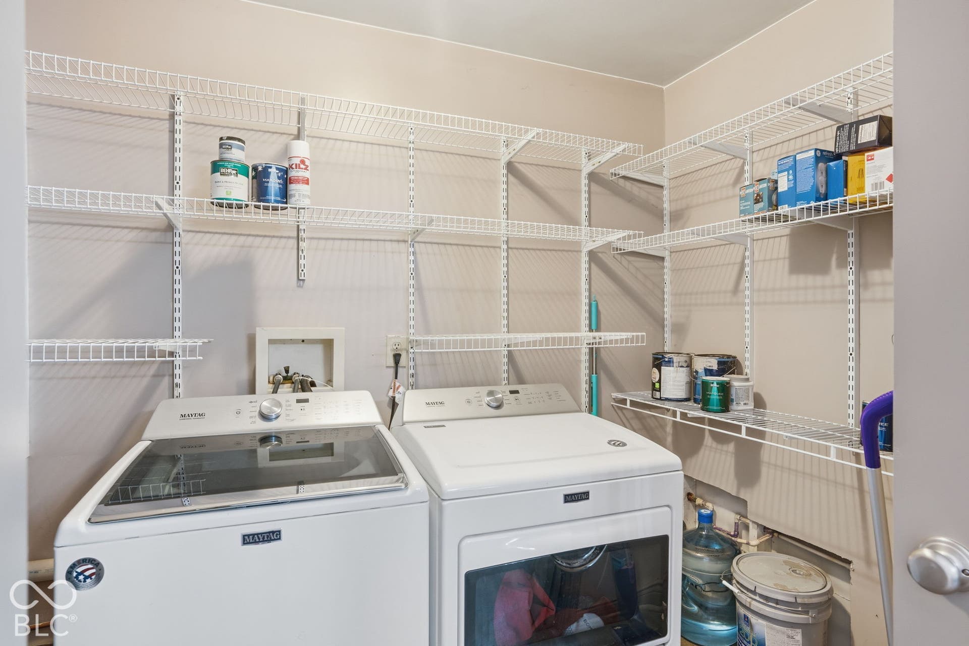 4937 E Edgewood, Indianapolis, IN 46237 Dedicated laundry room with extensive shelving and storage, ideal for keeping an active home and horse-property lifestyle organized.