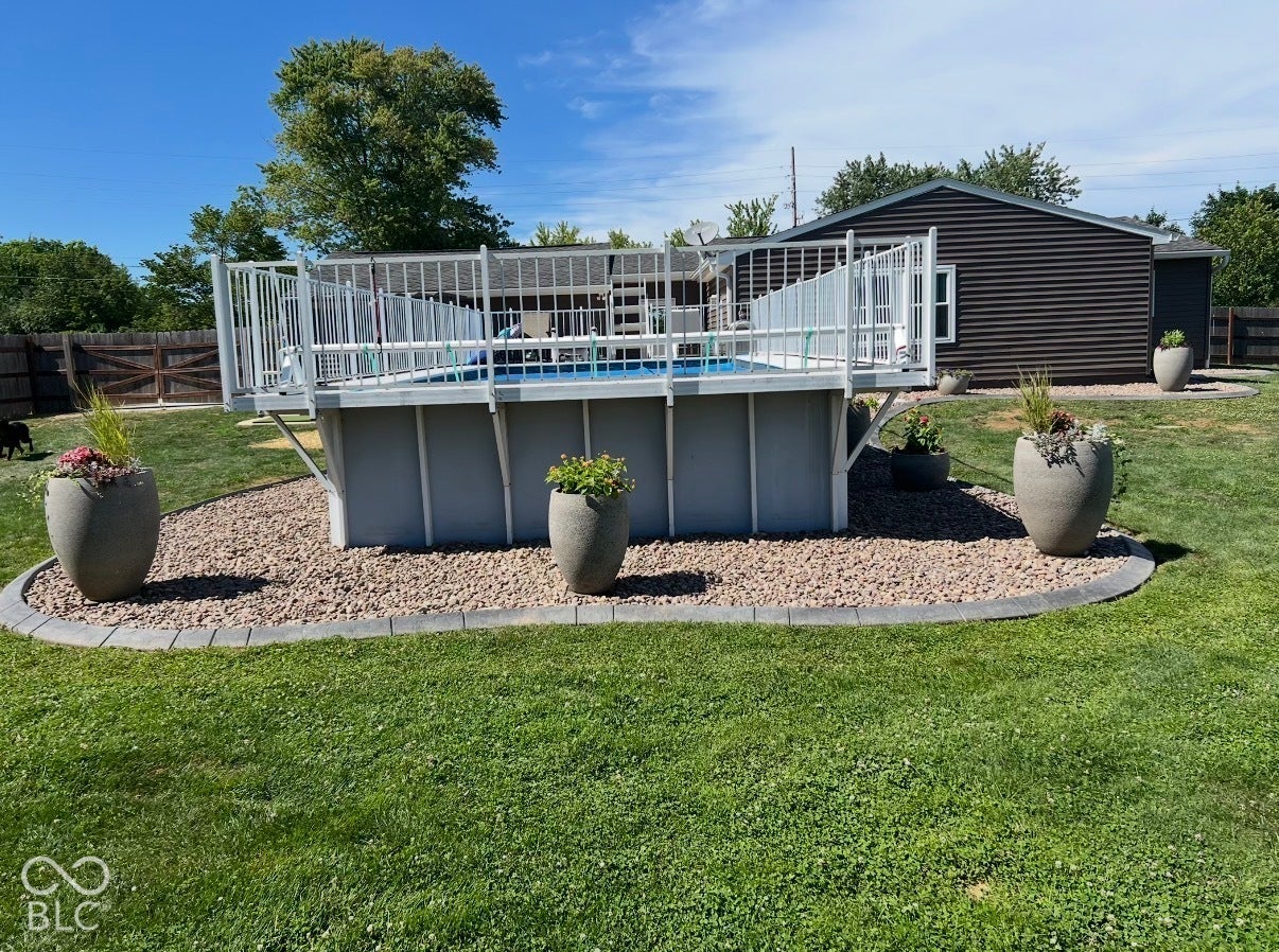 4937 E Edgewood, Indianapolis, IN 46237 Thoughtful landscaping, manicured lawn, decorative stonework, and established planters surround the pool, creating a polished outdoor space that feels every bit as cared for as the home itself.